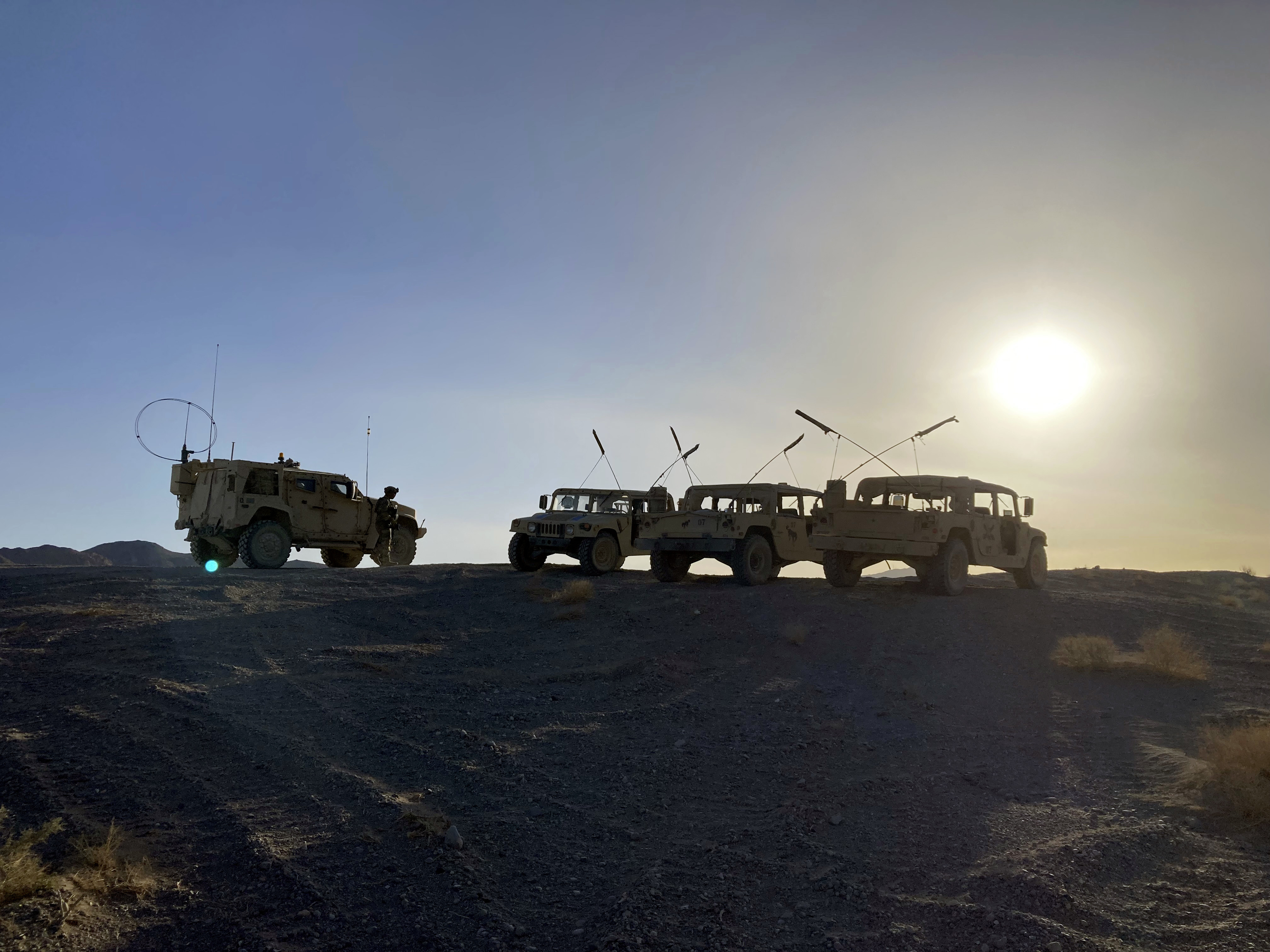 Army vehicles on the ridge, as soldiers from the 2nd Brigade, 1st Cavalry Division, prepare to attack the enemy in the town nearby, during an early morning training exercise at the National Training Center at Fort Irwin, Calif., on Tuesday.