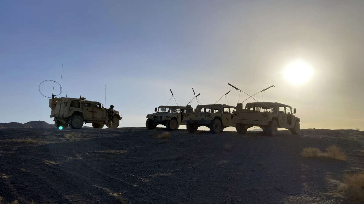 Army vehicles on the ridge, as soldiers from the 2nd Brigade, 1st Cavalry Division, prepare to attack the enemy in the town nearby, during an early morning training exercise at the National Training Center at Fort Irwin, Calif., on Tuesday.