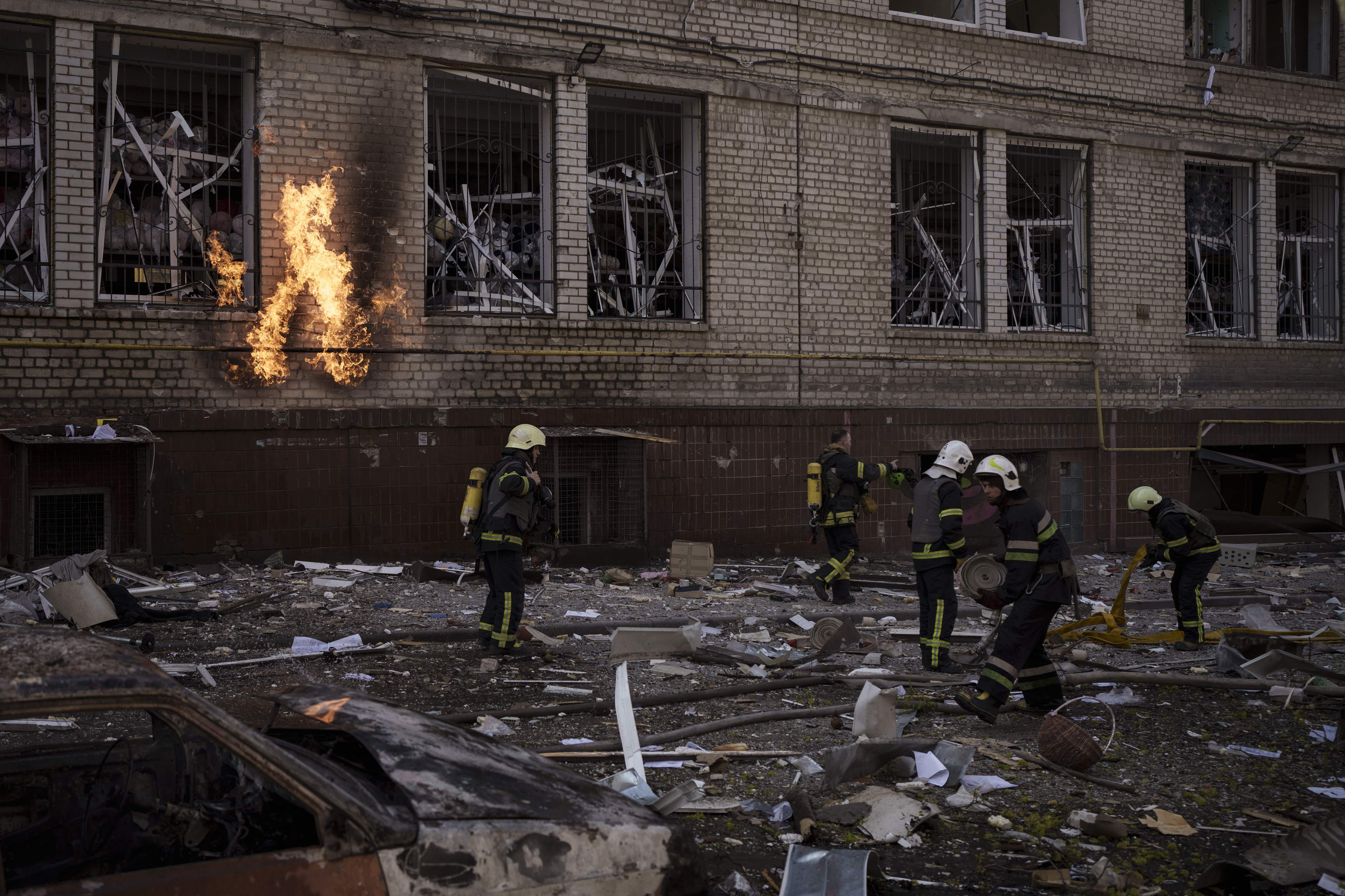 Firefighters work to extinguish multiple fires after a Russian attack in Kharkiv, Ukraine, Saturday.