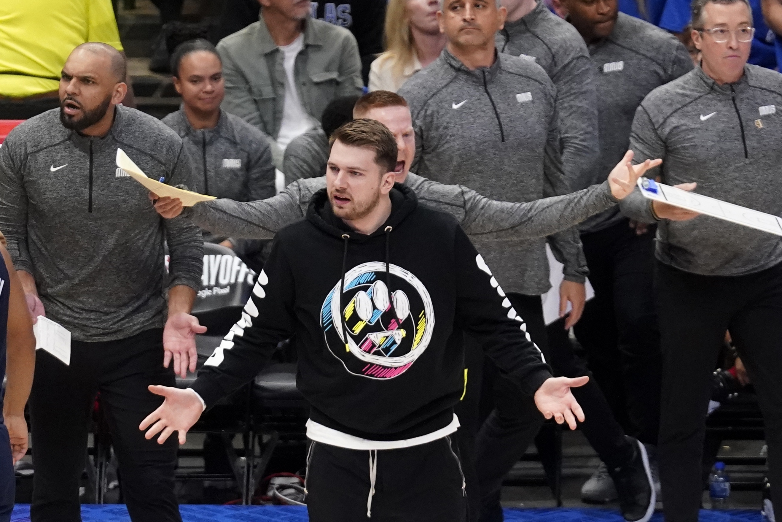 Dallas Mavericks guard Luka Doncic looks to an official as he watches play from the bench in the first half of Game 1 of an NBA basketball first-round playoff series against the Utah Jazz, Saturday, April 16, 2022, in Dallas.