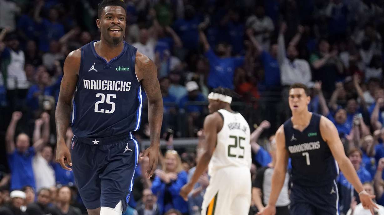 Dallas Mavericks forward Reggie Bullock (25) celebrates his three-point basket as he runs up court in the first half of Game 1 of an NBA basketball first-round playoff series against the Utah Jazz, Saturday, April 16, 2022, in Dallas.