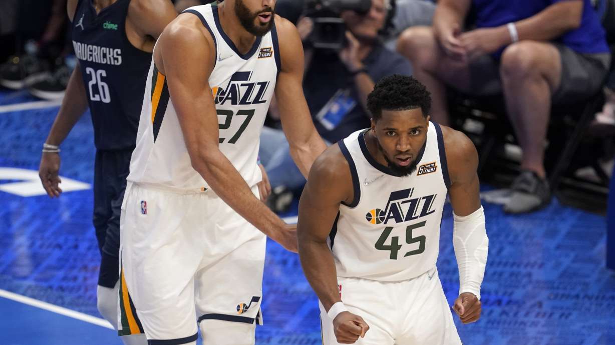 Utah Jazz's Rudy Gobert (27) and Donovan Mitchell (45) celebrate a basket by Mitchell in the second half of Game 1 of an NBA basketball first-round playoff series against the Dallas Mavericks, Saturday, April 16, 2022, in Dallas.