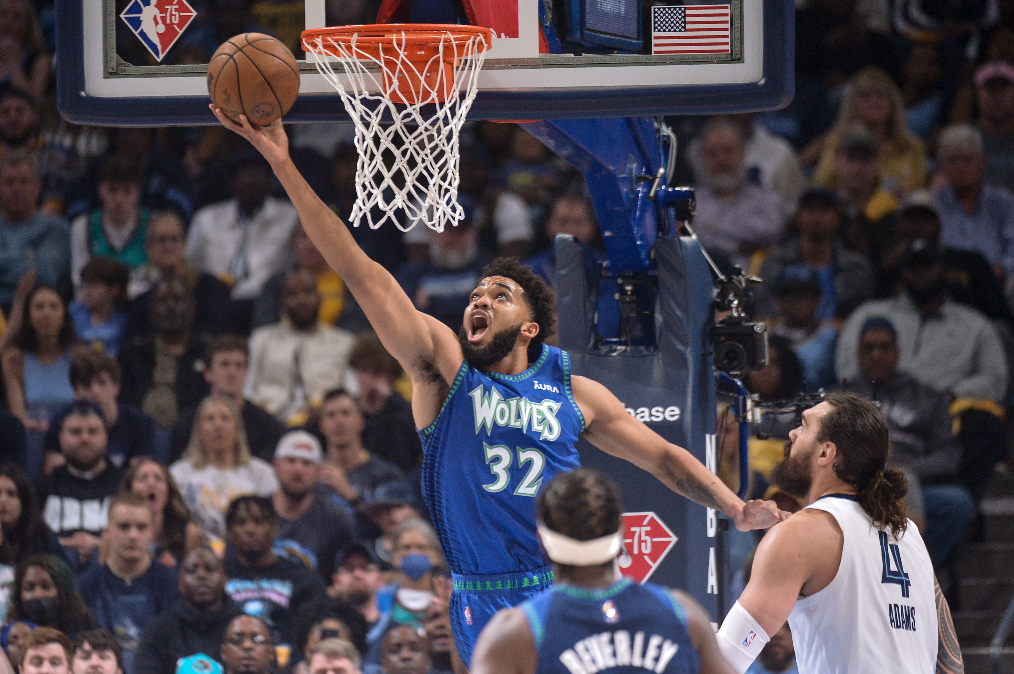 Minnesota Timberwolves center Karl-Anthony Towns (32) shoots ahead of Memphis Grizzlies center Steven Adams (4) during the first half of Game 1 of a first-round NBA basketball playoff series Saturday, April 16, 2022, in Memphis, Tenn. 