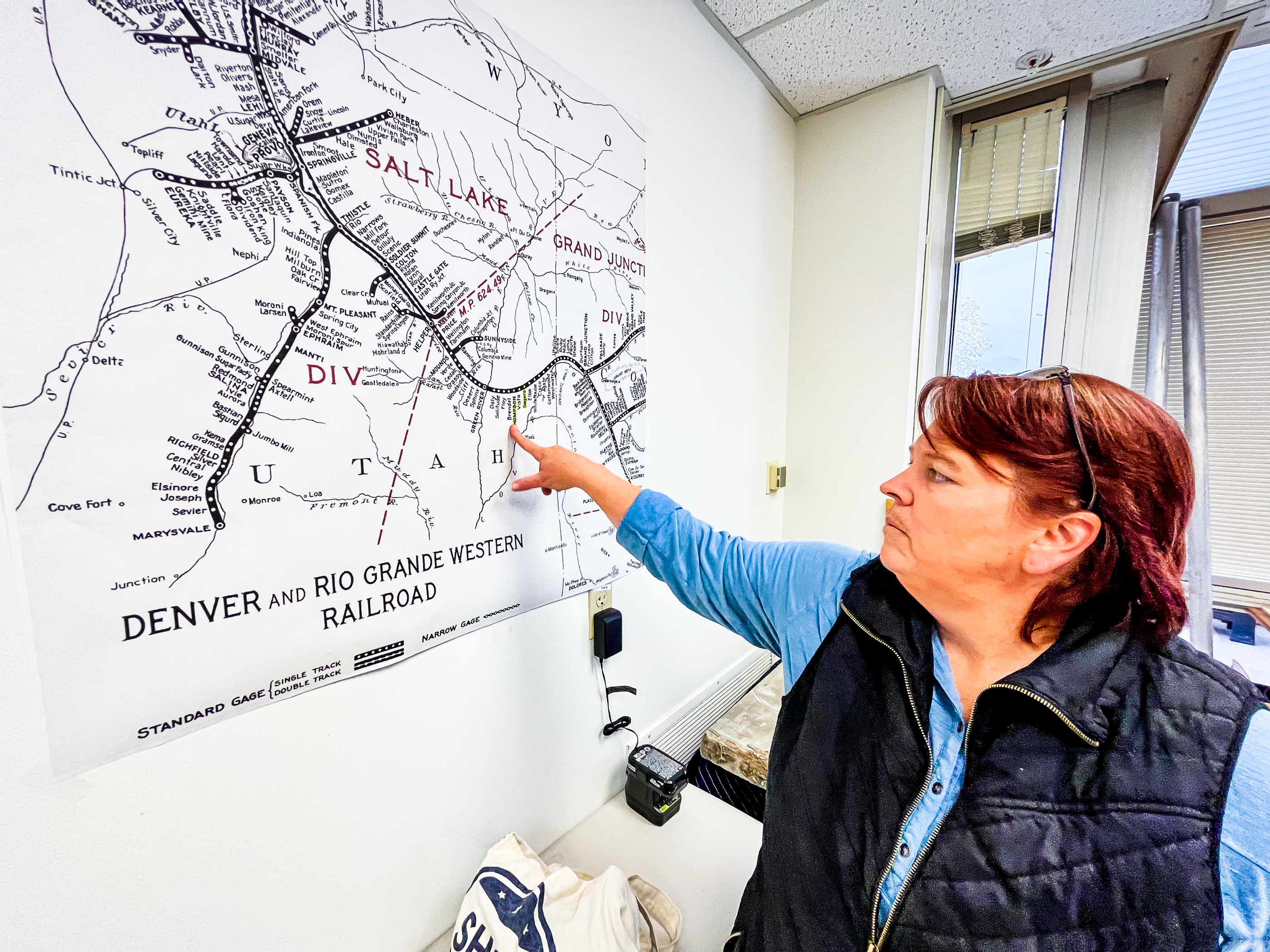 Amy Barry, cemeteries program manager for the Utah Division of State History, points to an old Denver and Rio Grande Western Railway map from the 1900s, when most of the railroad workers were Japanese immigrants.