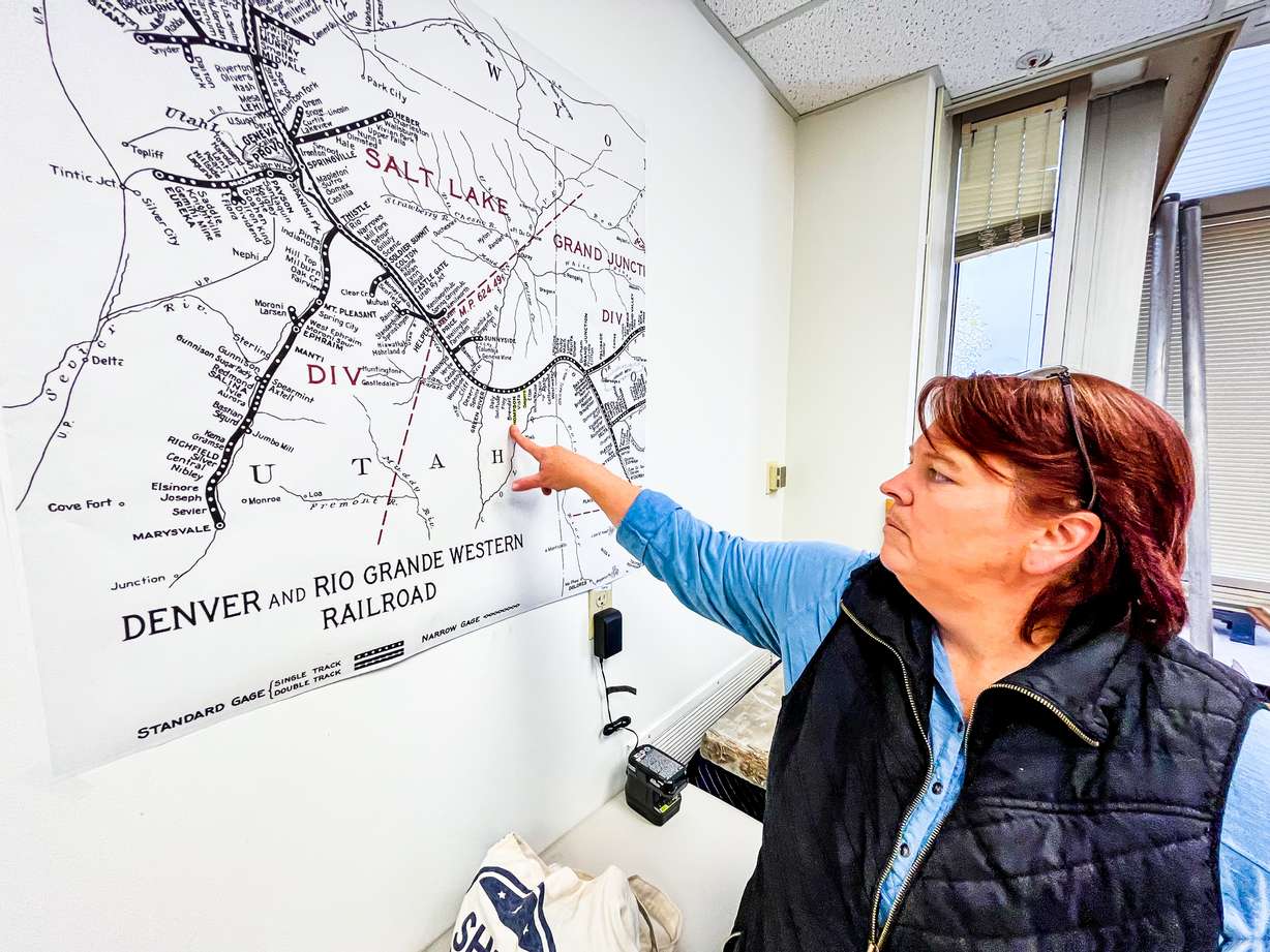 Amy Barry, cemeteries program manager for the Utah Division of State History, points to an old Denver and Rio Grande Western Railway map from the 1900s, when most of the railroad workers were Japanese immigrants.