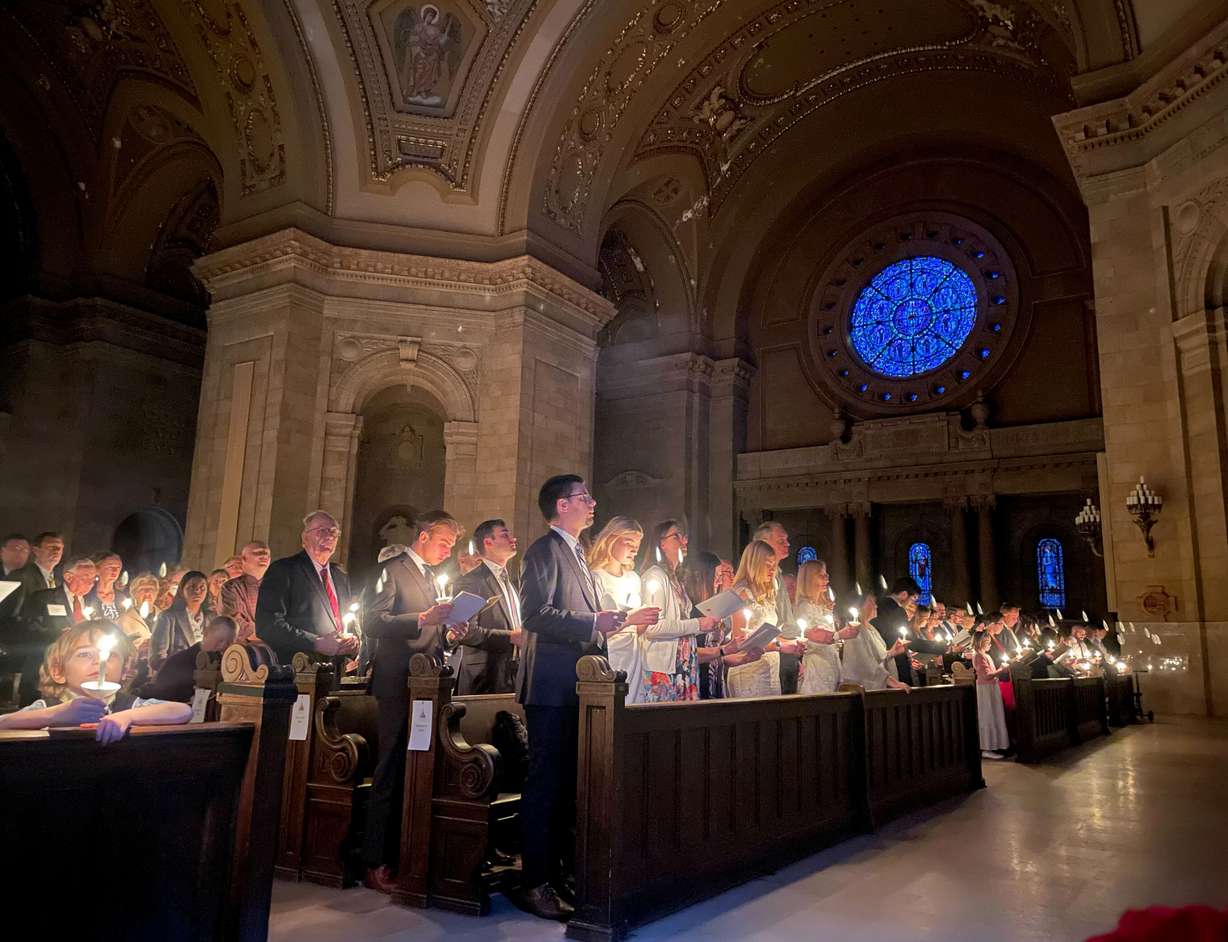 Hundreds of people light candles at the beginning of the Easter Vigil Mass at the Cathedral of St. Paul in St. Paul, Minn., on Saturday. For many U.S. Christians, this weekend marks the first time since 2019 that they will gather in person on Easter Sunday, a welcome chance to celebrate one of the year's holiest days side by side with fellow congregants.
