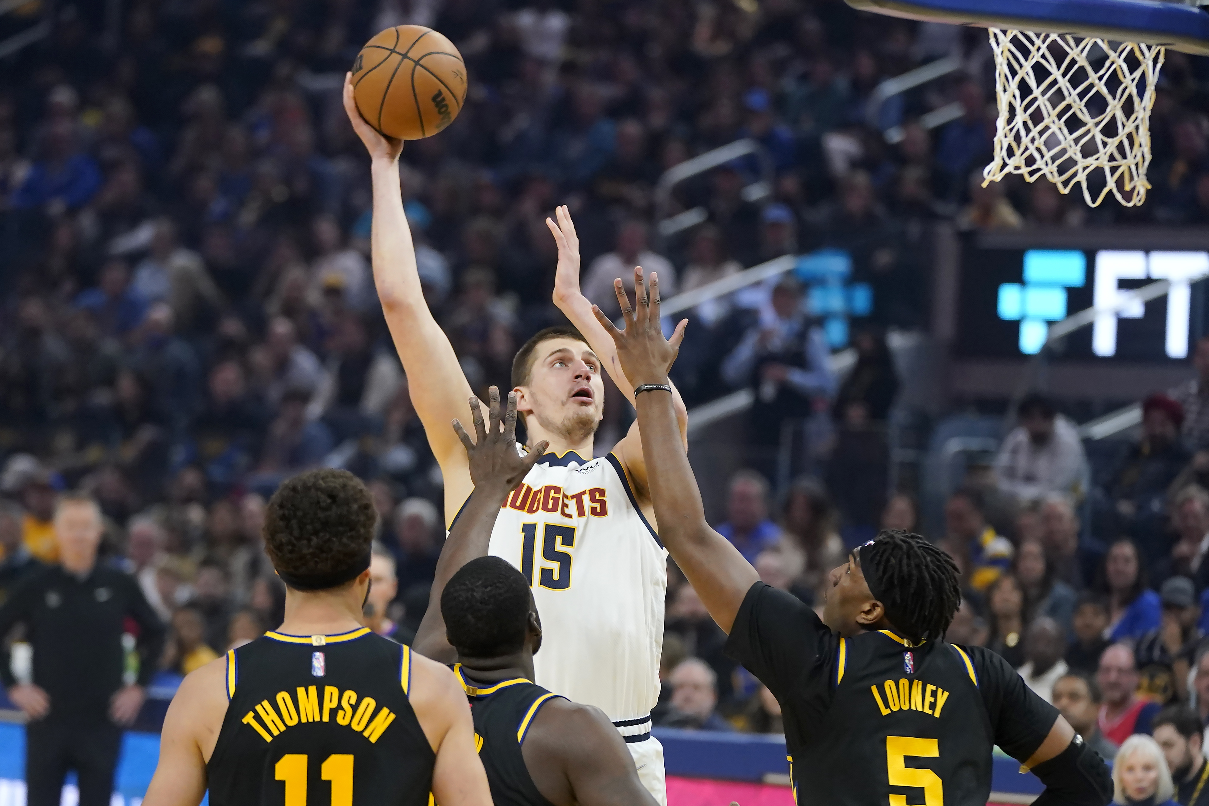 Denver Nuggets center Nikola Jokic (15) shoots against the Golden State Warriors during the first half of Game 1 of an NBA basketball first-round playoff series in San Francisco, Saturday, April 16, 2022. 