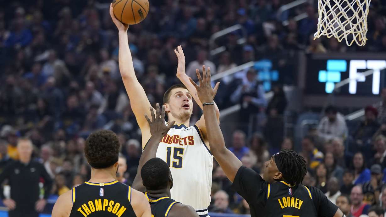 Denver Nuggets center Nikola Jokic (15) shoots against the Golden State Warriors during the first half of Game 1 of an NBA basketball first-round playoff series in San Francisco, Saturday, April 16, 2022.
