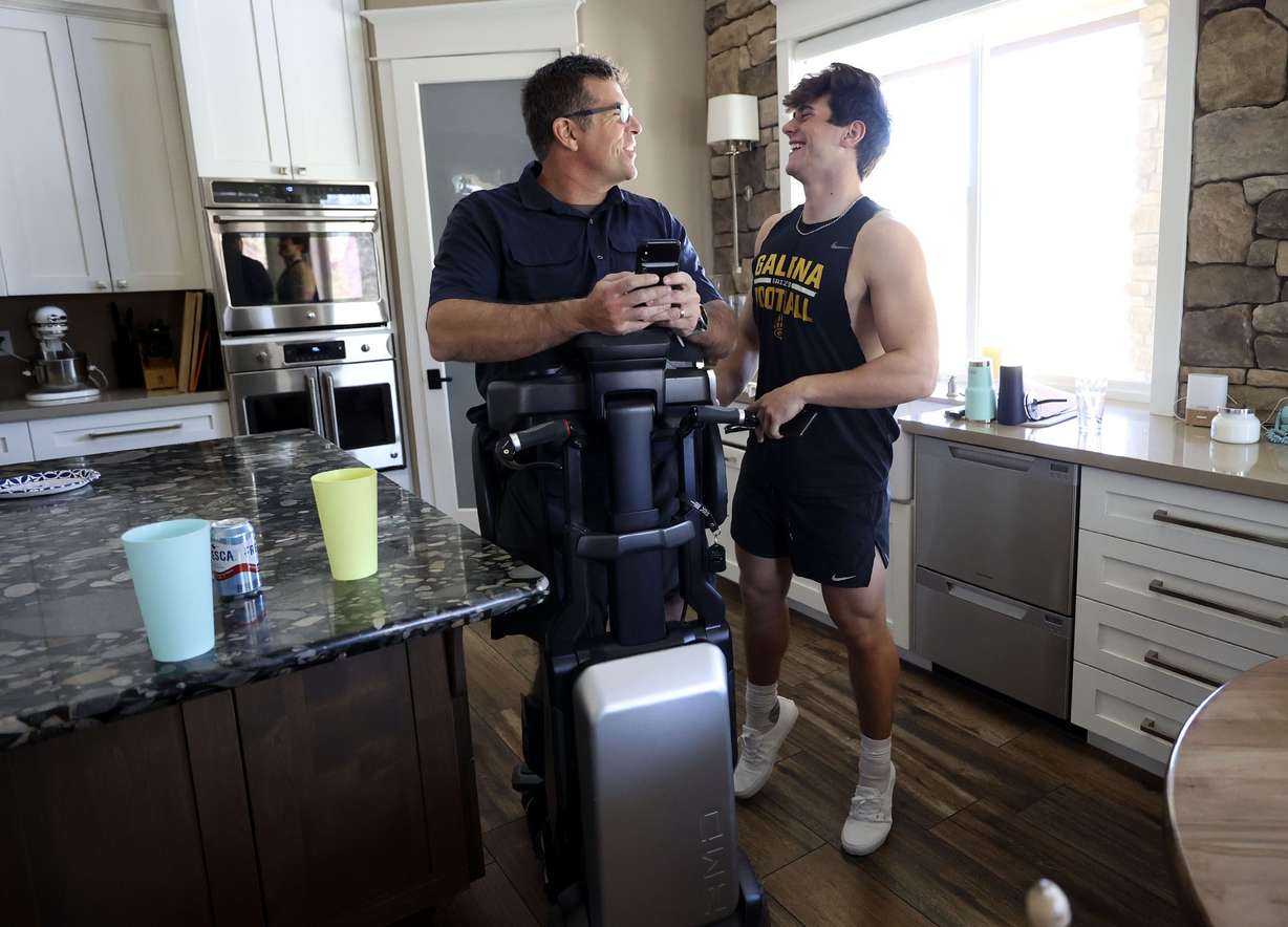 Bill Winchester jokes with his son, Luke, that even on tippy-toe Luke isn’t as tall as Bill when Bill uses his Tek RMD at their home in Reno, Nevada, on Monday, March 21.
