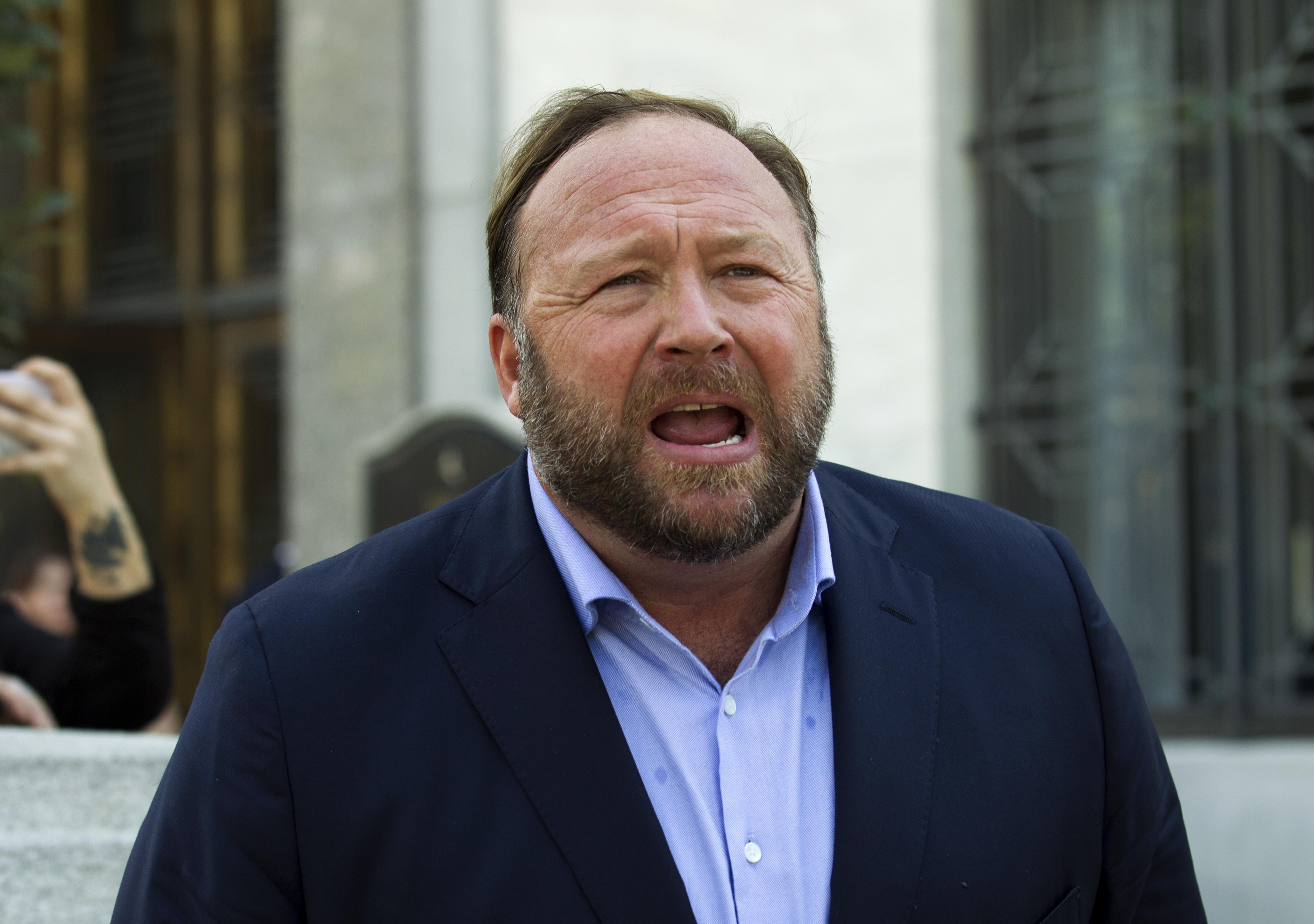 Alex Jones speaks to reporters in Washington, Sept. 5, 2018. Infowars filed for Chapter 11 bankruptcy protection on Sunday in Texas as its founder (Jones) faces defamation lawsuits over his comments that the Sandy Hook Elementary School shooting was a hoax.