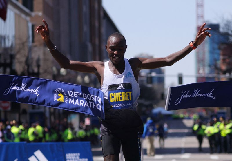 Athletics - Boston Marathon - Boston, Massachusetts, U.S. - April 18, 2022 Kenya's Evans Chebet celebrates winning the elite men's race