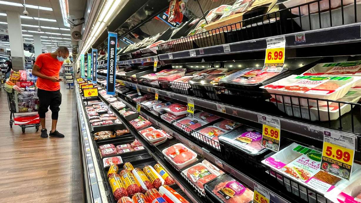 A person shops in the meat section of a grocery store on Nov. 11, 2021, in Los Angeles. Consumers around the world are paying more for goods and services.