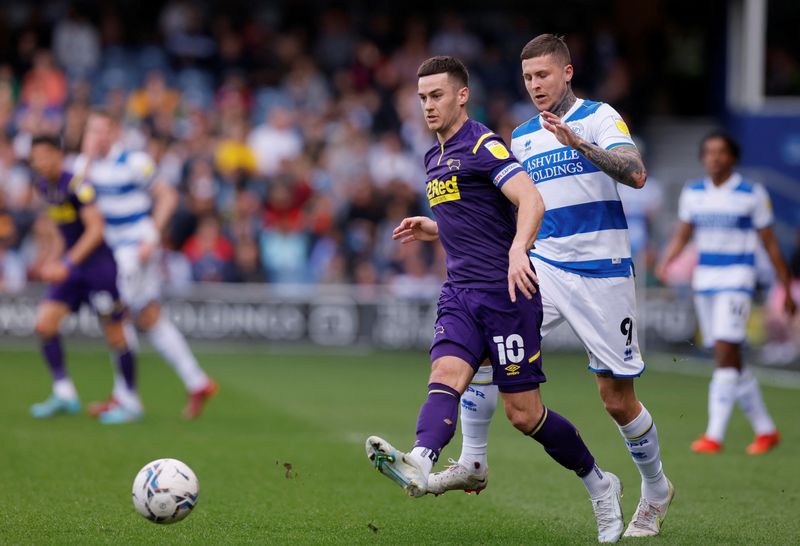 Soccer Football - Championship - Queens Park Rangers v Derby County - Loftus Road, London, Britain - April 18, 2022 Derby County's Tom Lawrence in action with Queens Park Rangers' Lyndon Dykes  Action Images/Andrew Couldridge