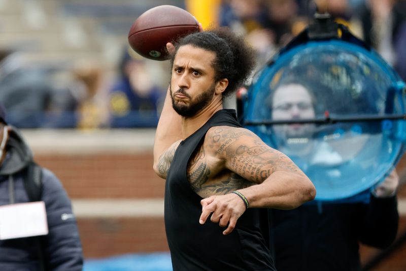 FILE PHOTO: Apr 2, 2022; Ann Arbor, Michigan, USA;  Colin Kaepernick passes during halftime at the Michigan Spring game at Michigan Stadium.