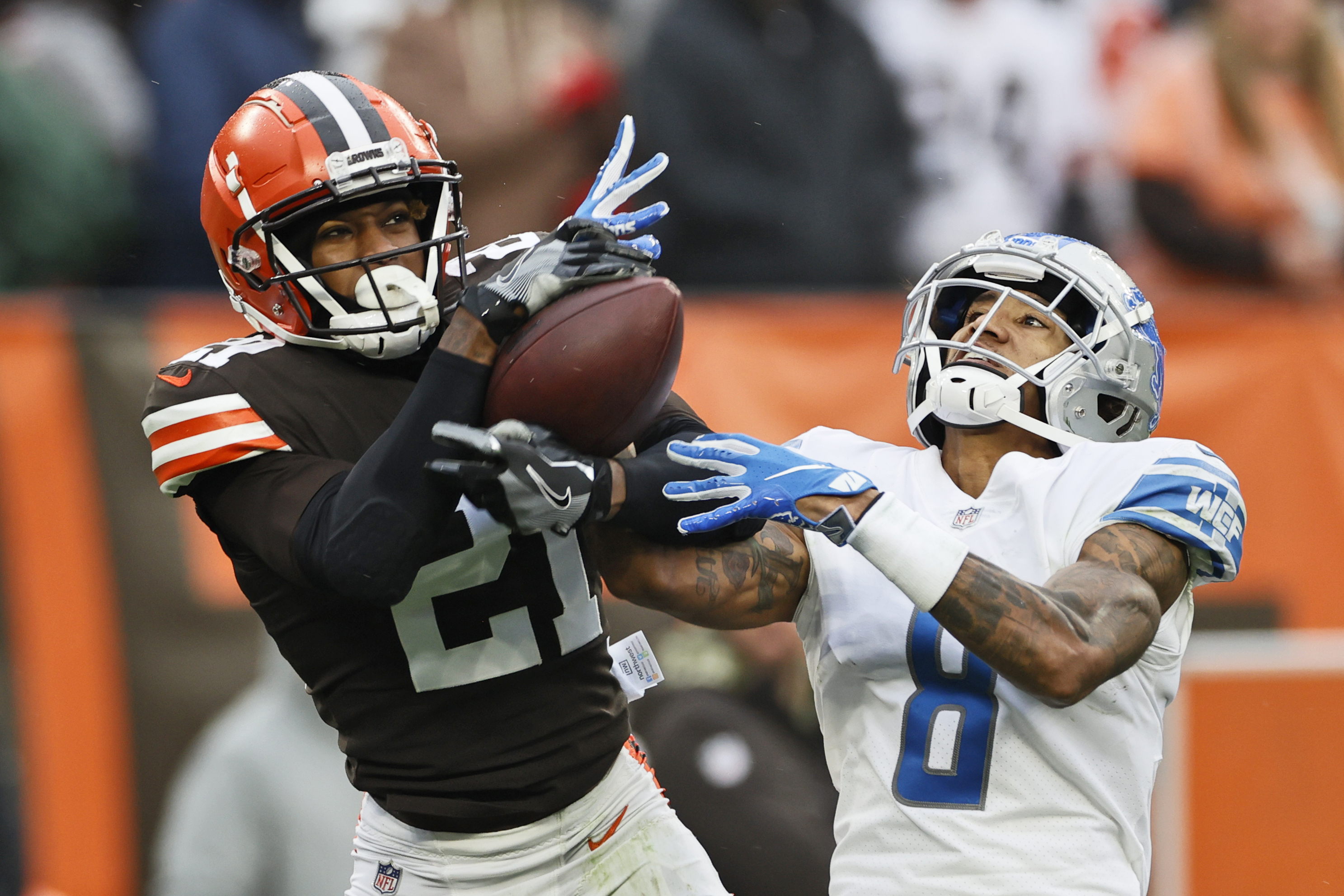 FILE - Cleveland Browns cornerback Denzel Ward (21) intercepts a pass intended for Detroit Lions wide receiver Josh Reynolds (8) during the second half of an NFL football game, Sunday, Nov. 21, 2021, in Cleveland. Cleveland Browns Pro Bowl cornerback Denzel Ward has agreed to a five-year, $100.5 million contract extension with the team, a person familiar with the negotiations told The Associated Press on Monday, April 18, 2022. 