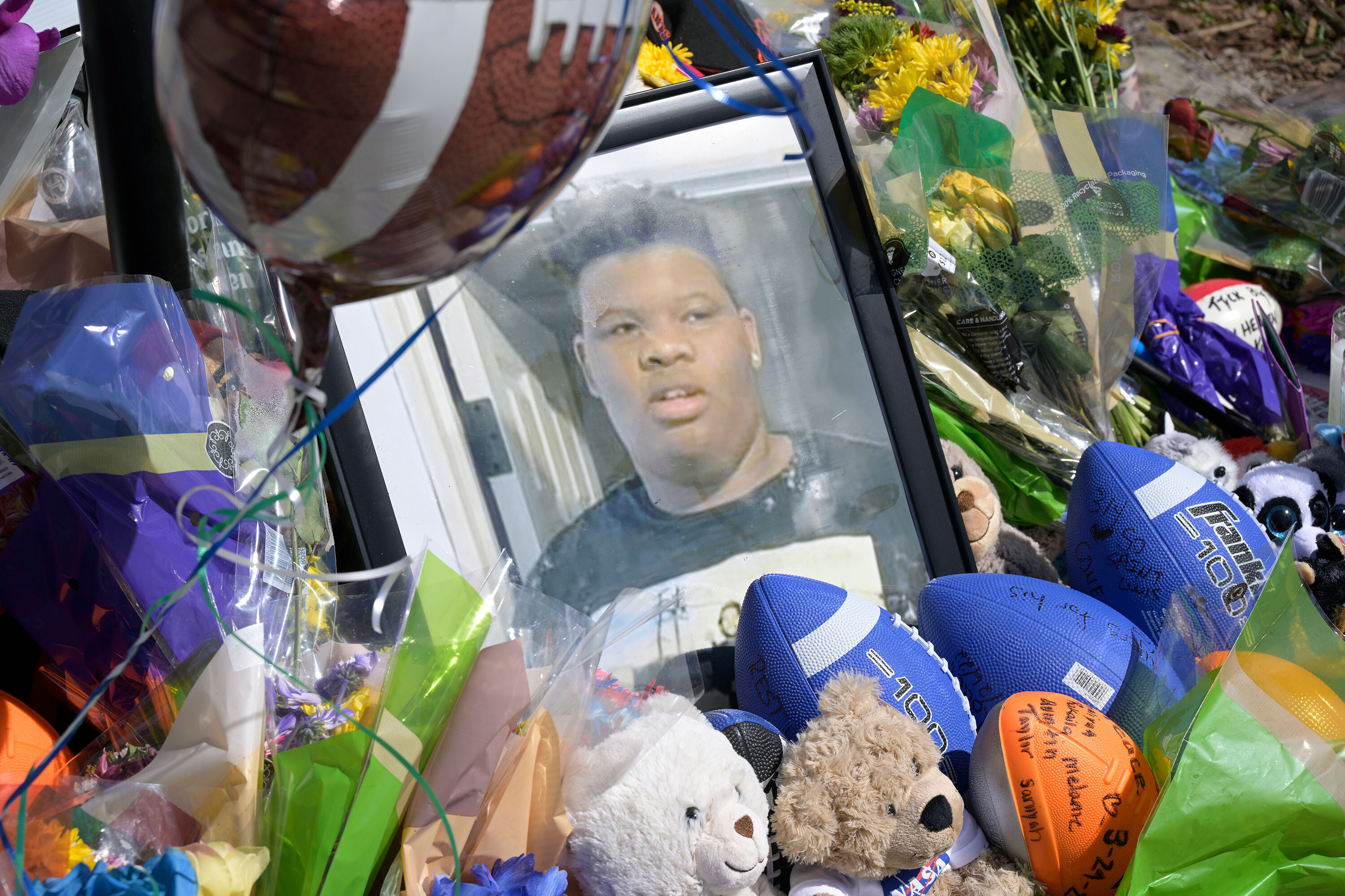 A makeshift memorial for Tyre Sampson is seen outside the Orlando Free Fall ride. Two seats on a ride had been manually adjusted, a forensic engineering firm found Monday.