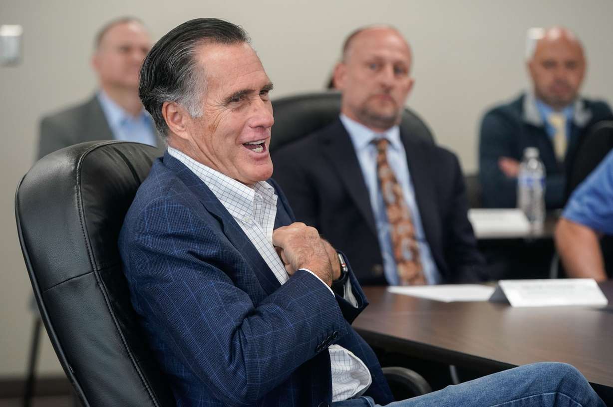 Sen. Mitt Romney, R-Utah, talks to Kenworth Sales employees before a tour of the company in West Valley City on Friday, Nov. 12, 2021. During the tour, Romney talked about supply chain issues.
