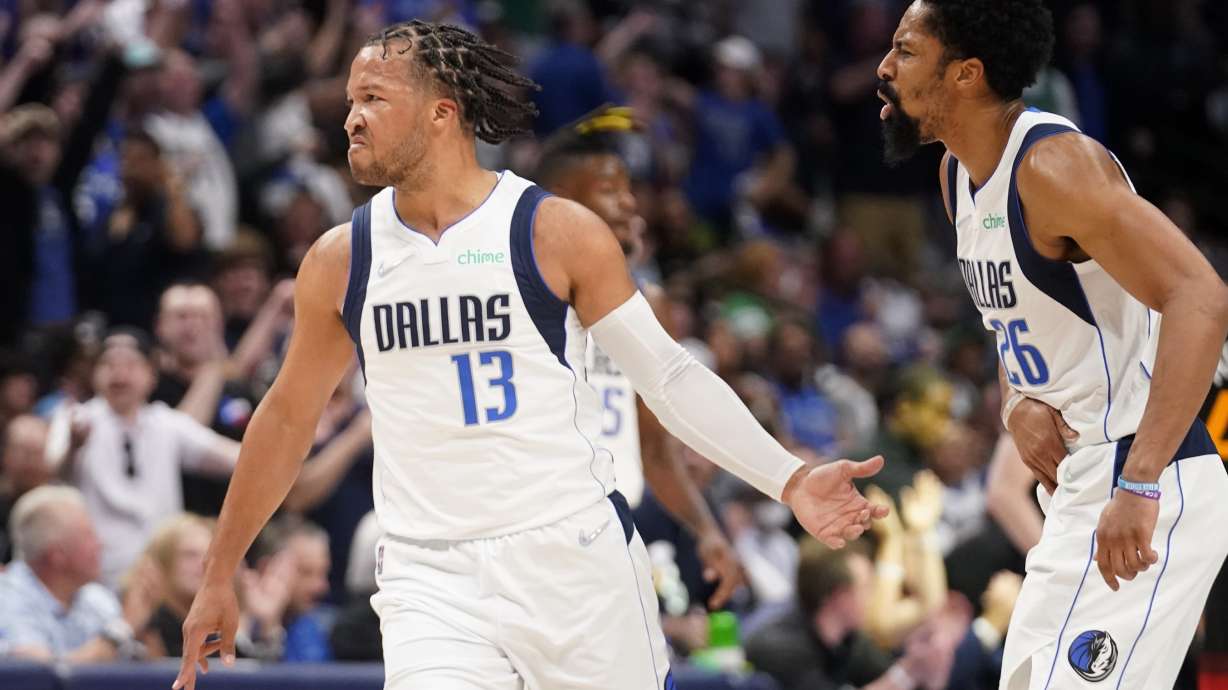 Dallas Mavericks guard Jalen Brunson (13) and Spencer Dinwiddie, right, celebrate a 3-point basket made by Brunson in the first half of Game 2 of an NBA basketball first-round playoff series against the Utah Jazz, Monday, April 18, 2022, in Dallas.