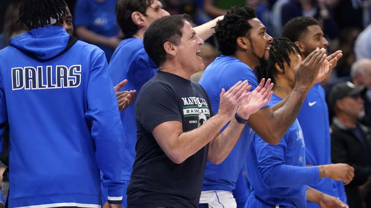 Dallas Mavericks team owner Mark Cuban, center, and players on the bench cheer on their team's play against the Utah Jazz in the first half of Game 2 of an NBA basketball first-round playoff series, Monday, April 18, 2022, in Dallas.