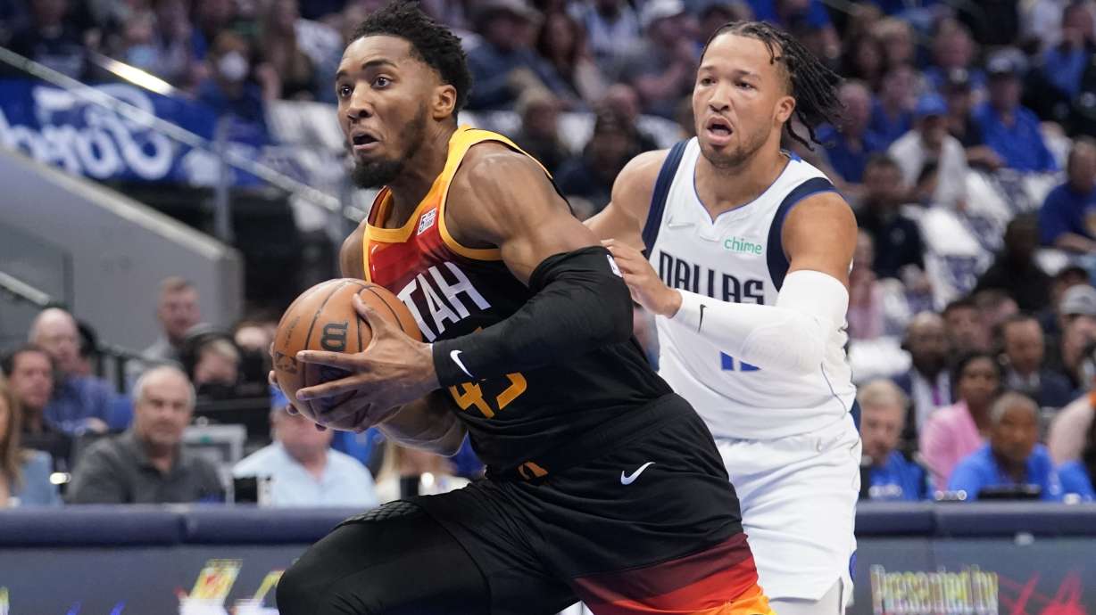 Utah Jazz guard Donovan Mitchell (45) drives to the basket past Dallas Mavericks guard Jalen Brunson, right, in the first half of Game 2 of an NBA basketball first-round playoff series, Monday, April 18, 2022, in Dallas.