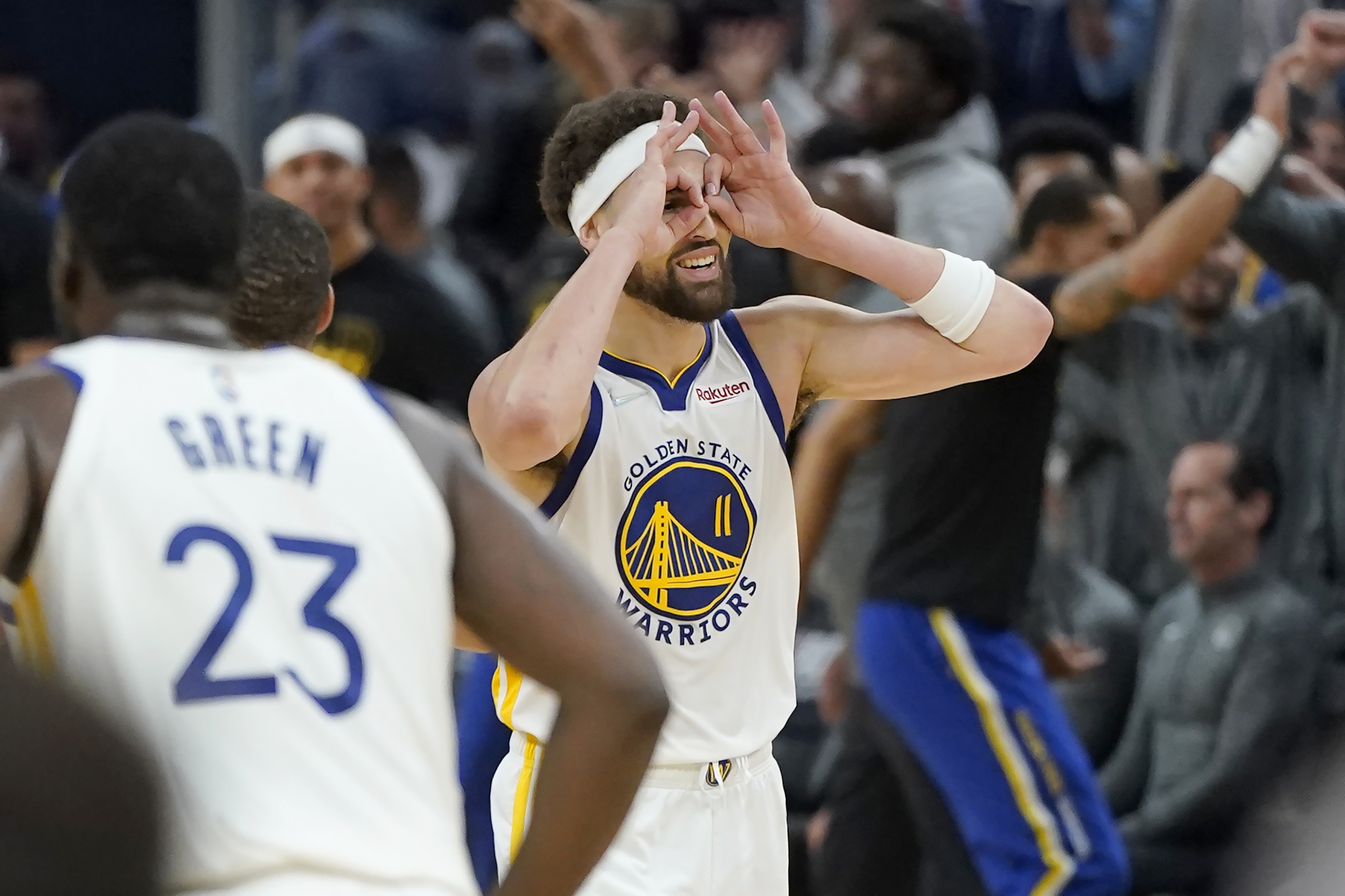 Golden State Warriors guard Klay Thompson (11) gestures after teammate Stephen Curry's 3-point basket during the first half of Game 2 of an NBA basketball first-round playoff series against the Denver Nuggets in San Francisco, Monday, April 18, 2022. 