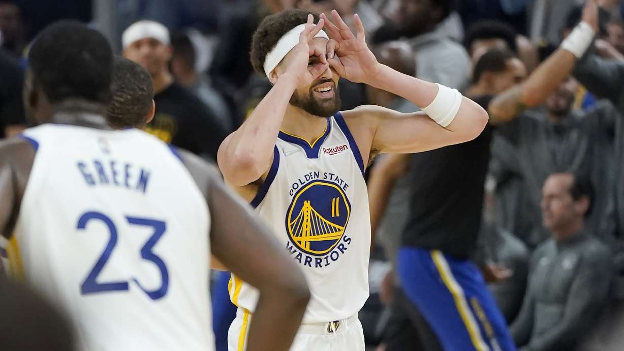 Golden State Warriors guard Klay Thompson (11) gestures after teammate Stephen Curry's 3-point basket during the first half of Game 2 of an NBA basketball first-round playoff series against the Denver Nuggets in San Francisco, Monday, April 18, 2022.