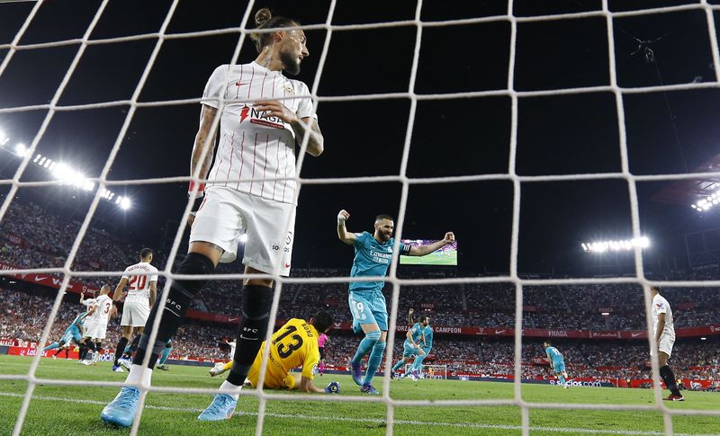 Soccer Football - LaLiga - Sevilla v Real Madrid - Ramon Sanchez Pizjuan, Seville, Spain - April 17, 2022 Real Madrid's Nacho celebrates scoring their second goal with teammates