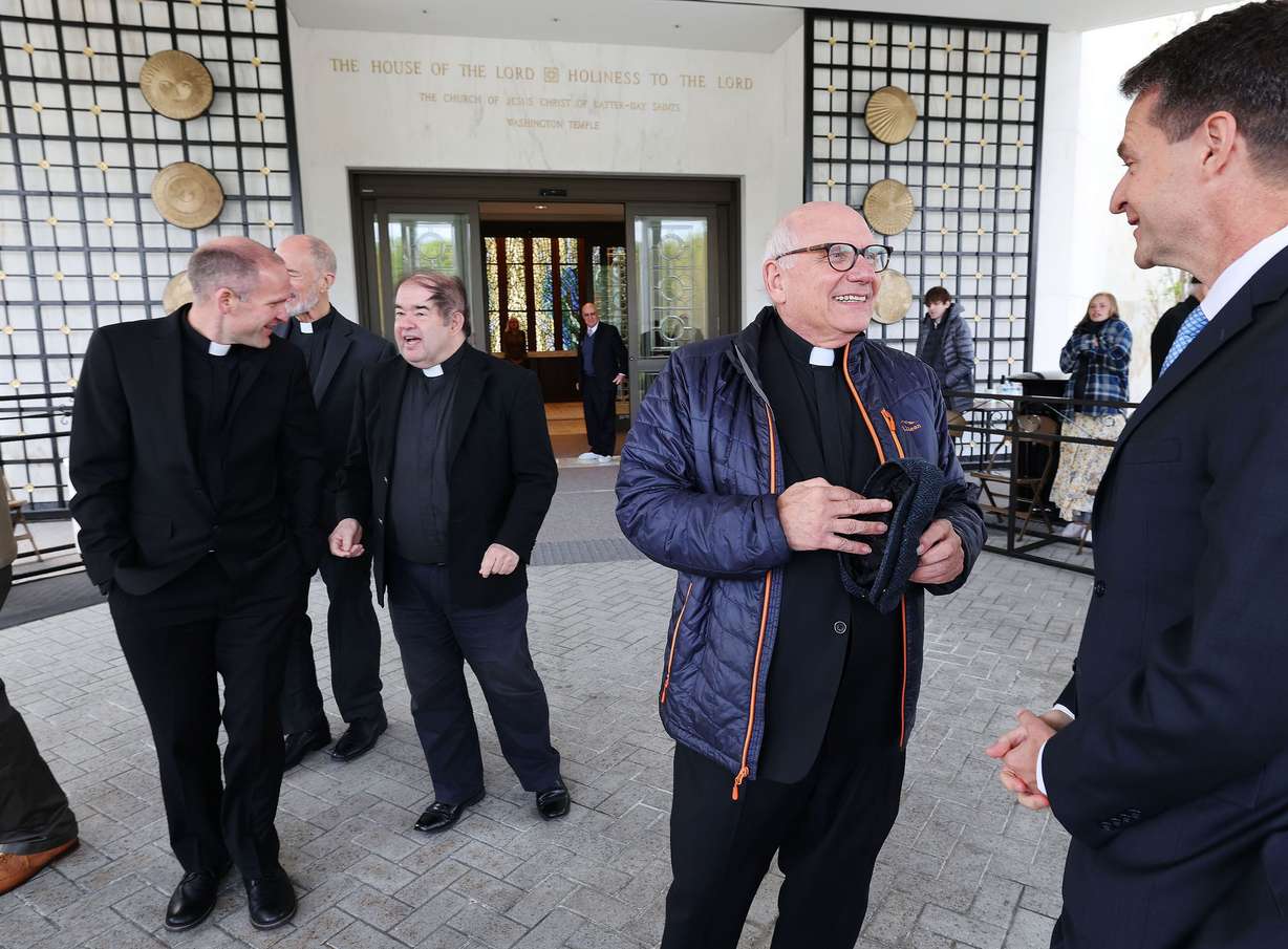 Father Ron Anton, of the Superior Jesuit Community, center, talks with Brooks Holtom, the soon-to-be mission president of the Mexico Mexico City North mission of The Church of Jesus Christ of Latter-day Saints, after touring the Washington D.C. Temple in Kensington, Maryland, on Tuesday.