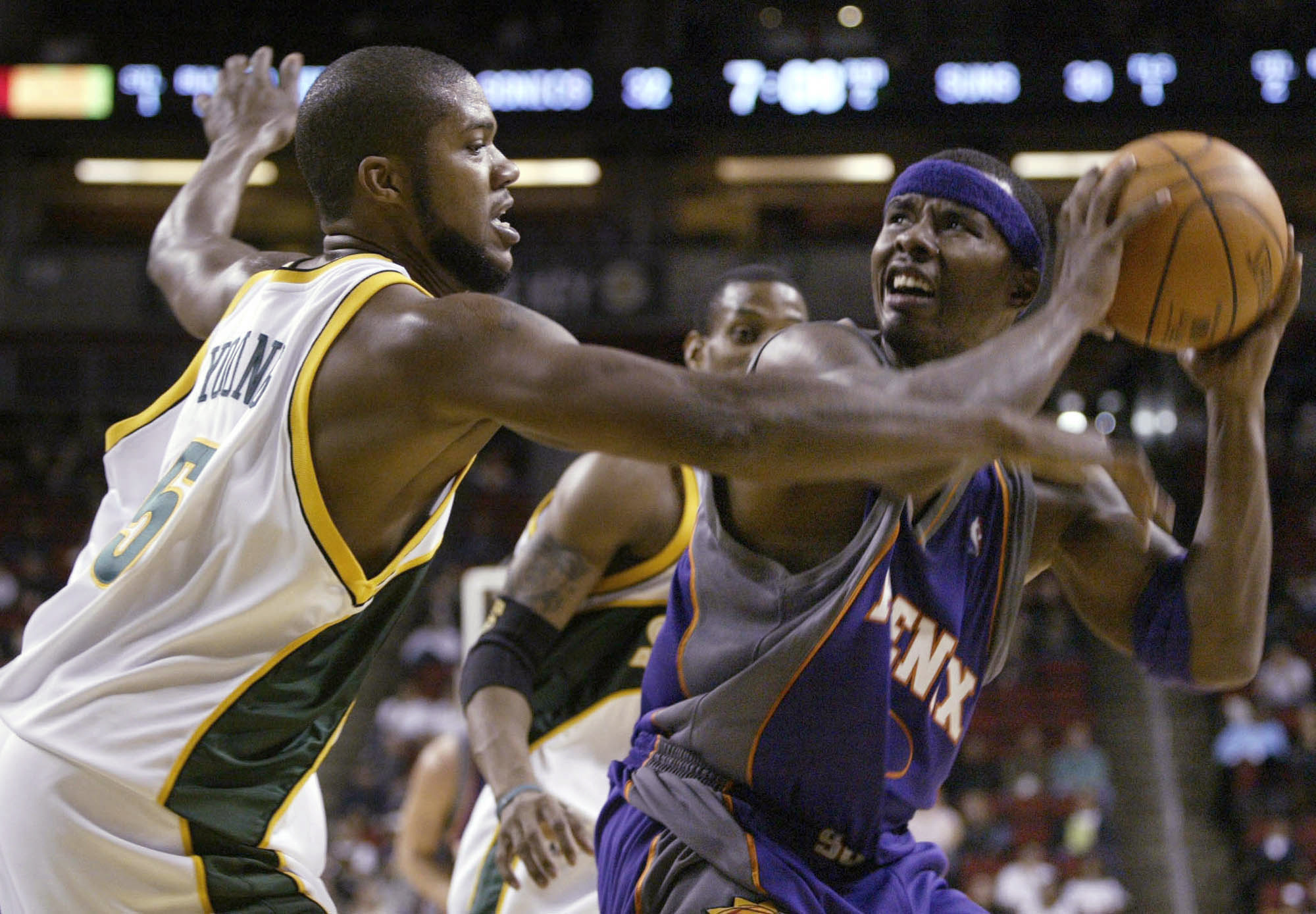FILE - Seattle SuperSonics' Galen Young (5) guards Phoenix Suns' Quentin Richardson during the first half of a preseason basketball game Saturday, Oct. 16, 2004, in Seattle. A woman who crashed her car into a Memphis house has been charged with vehicular homicide in the death of Galen Young, a former college and pro basketball player found dead in the home, prosecutors said Tuesday, April 19, 2022.