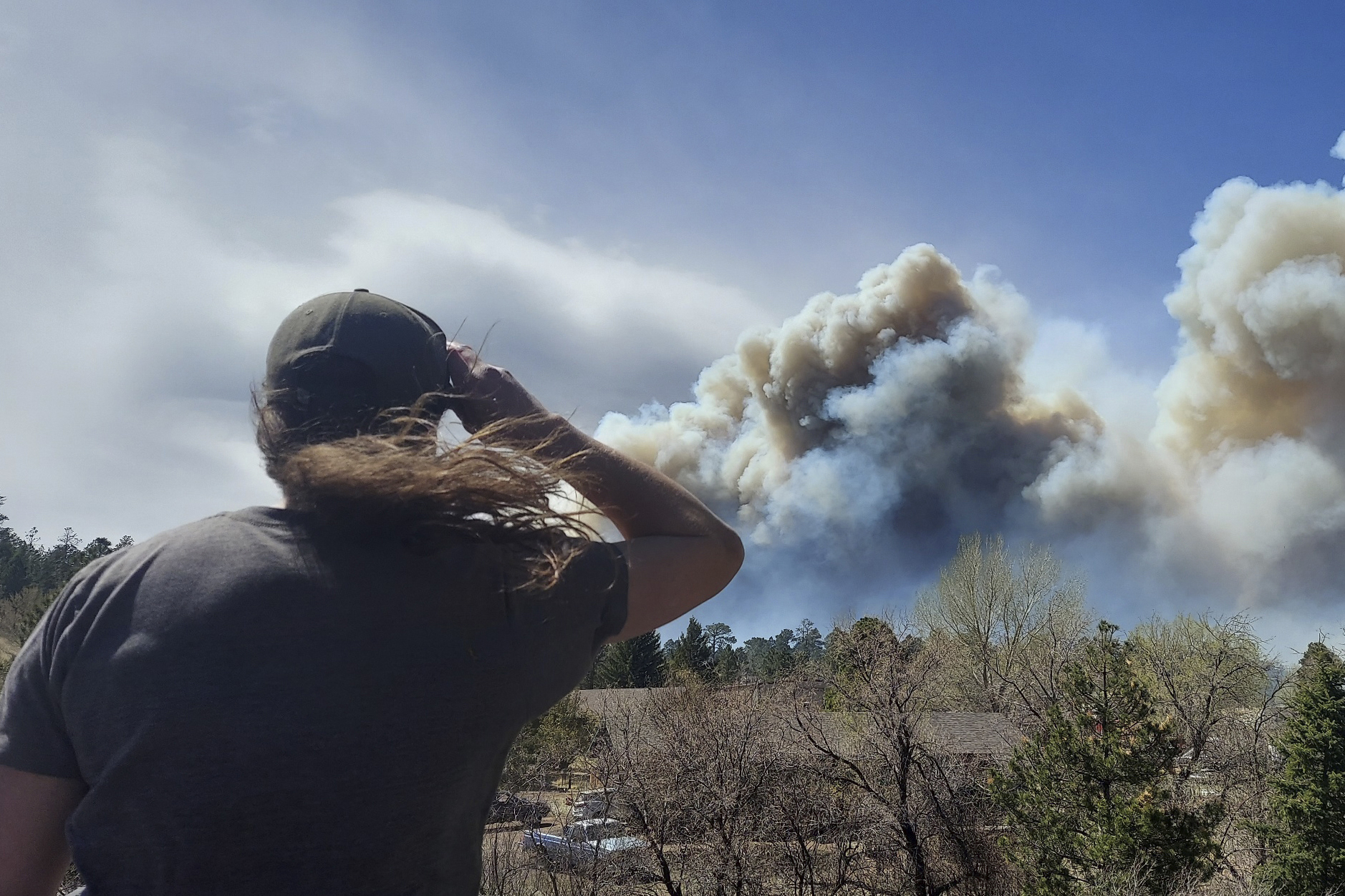 Smoke from a wind-whipped wildfire rises above neighborhoods on the outskirts of Flagstaff, Arizona, on Tuesday. Authorities issued evacuation orders for a couple hundred homes. 