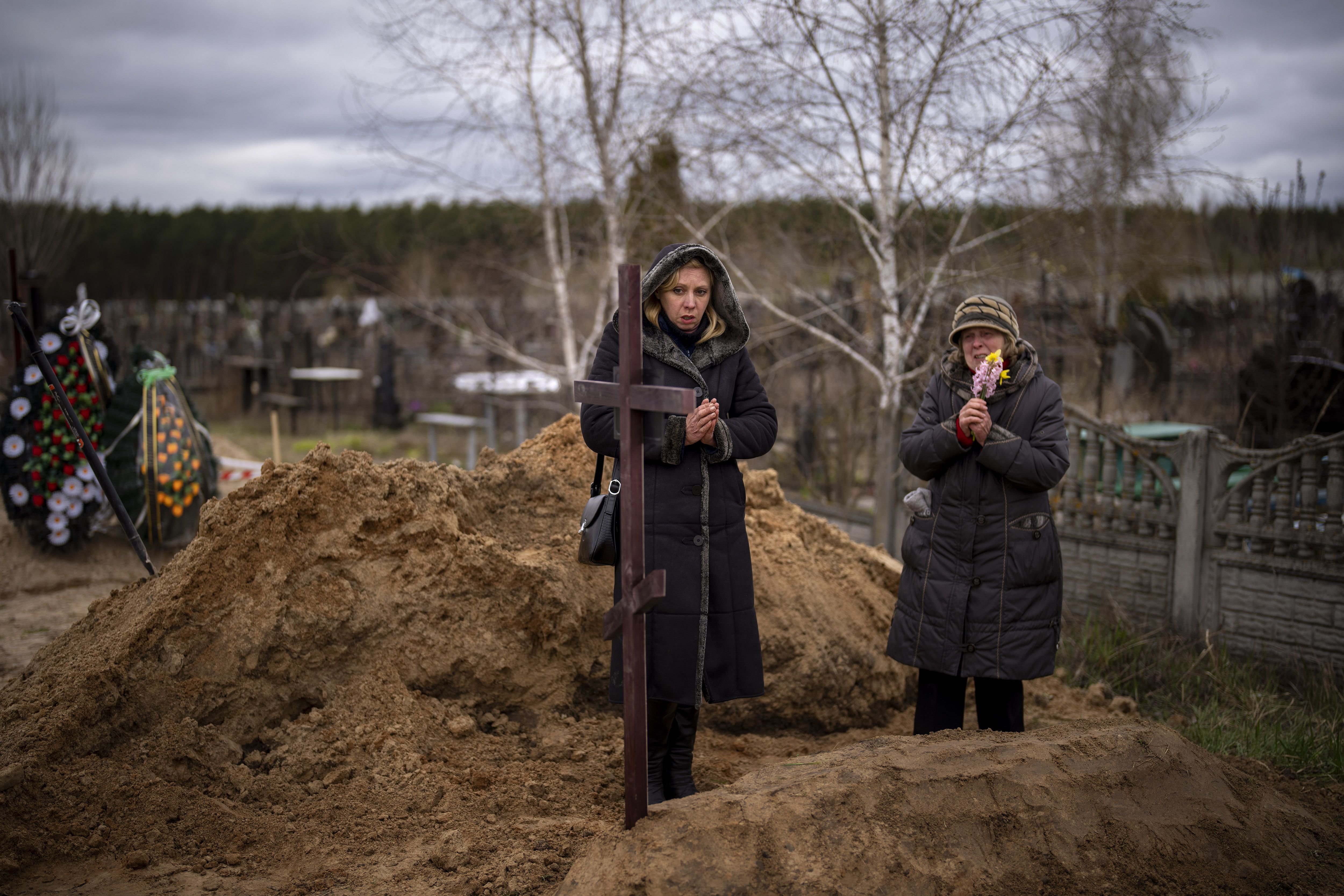 Vera Ptitsyna, 63, right, stands with her daughter Olena, 45, as she mourns on her husband’s grave, Yuriy Ptitsyn, 74, who died due to lack of medical care during the monthlong Russian occupation of the town, during his funeral in Bucha, in the outskirts of Kyiv, Tuesday. A vast majority of Utahns continue to closely follow the Russian war on Ukraine, and just under half don’t think the United States is doing to enough to respond.