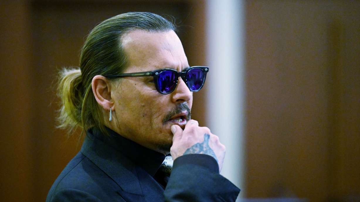 Actor Johnny Depp listens during a hearing at the Fairfax County Circuit Court in Fairfax, Va., Tuesday. Wednesday Depp scoffed at the notion during court testimony that his constant quarrels with ex-wife Amber Heard would ever prompt him to hit her.