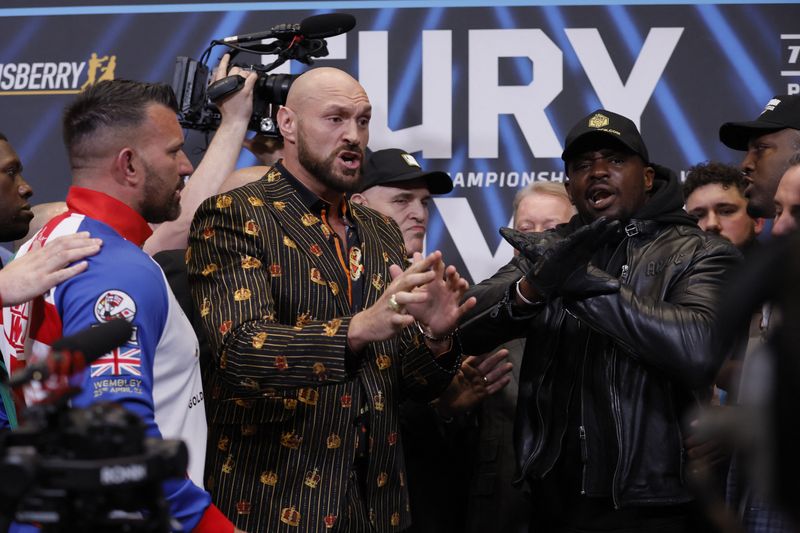 Boxing - Tyson Fury v Dillian Whyte Press Conference - Wembley Stadium, London, Britain - April 20, 2022 Tyson Fury and Dillian Whyte react with their security after the press conference Action Images via Reuters/Andrew Couldridge