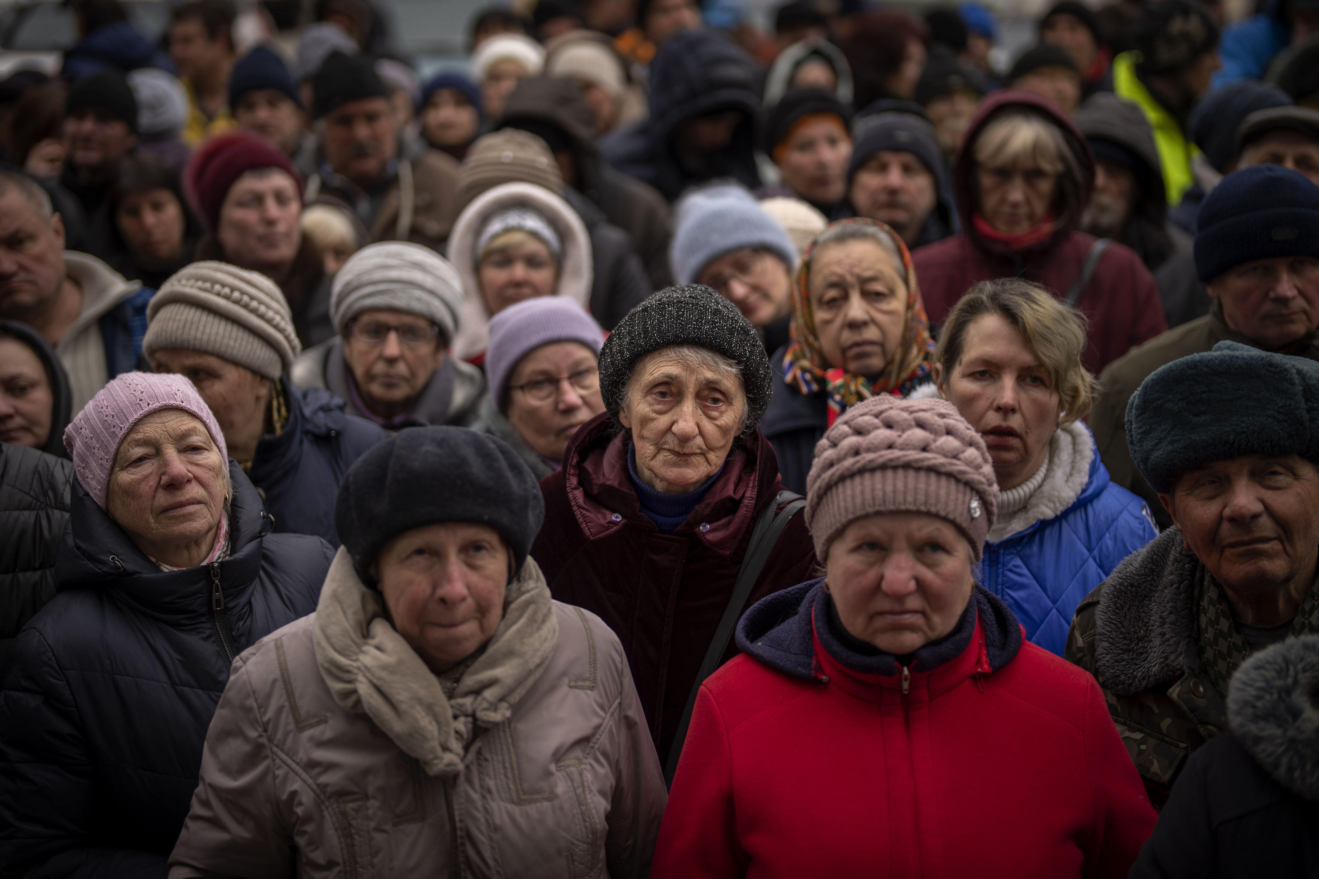 Ukrainians wait for a food distribution organised by the Red Cross in Bucha, on the outskirts of Kyiv, on Monday.