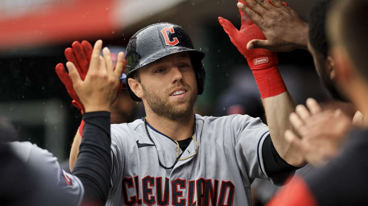 Cleveland Guardians' Owen Miller high-fives teammates after hitting a solo home run during the eighth inning of a baseball game against the Cincinnati Reds in Cincinnati, Wednesday, April 13, 2022. The Guardians won 7-3.