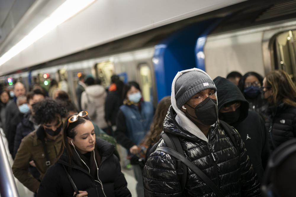 Mass transit riders wear masks as they commute in the financial district of lower Manhattan, Tuesday,  in New York. A majority of Americans continue to support a mask requirement for travelers, a new poll finds.