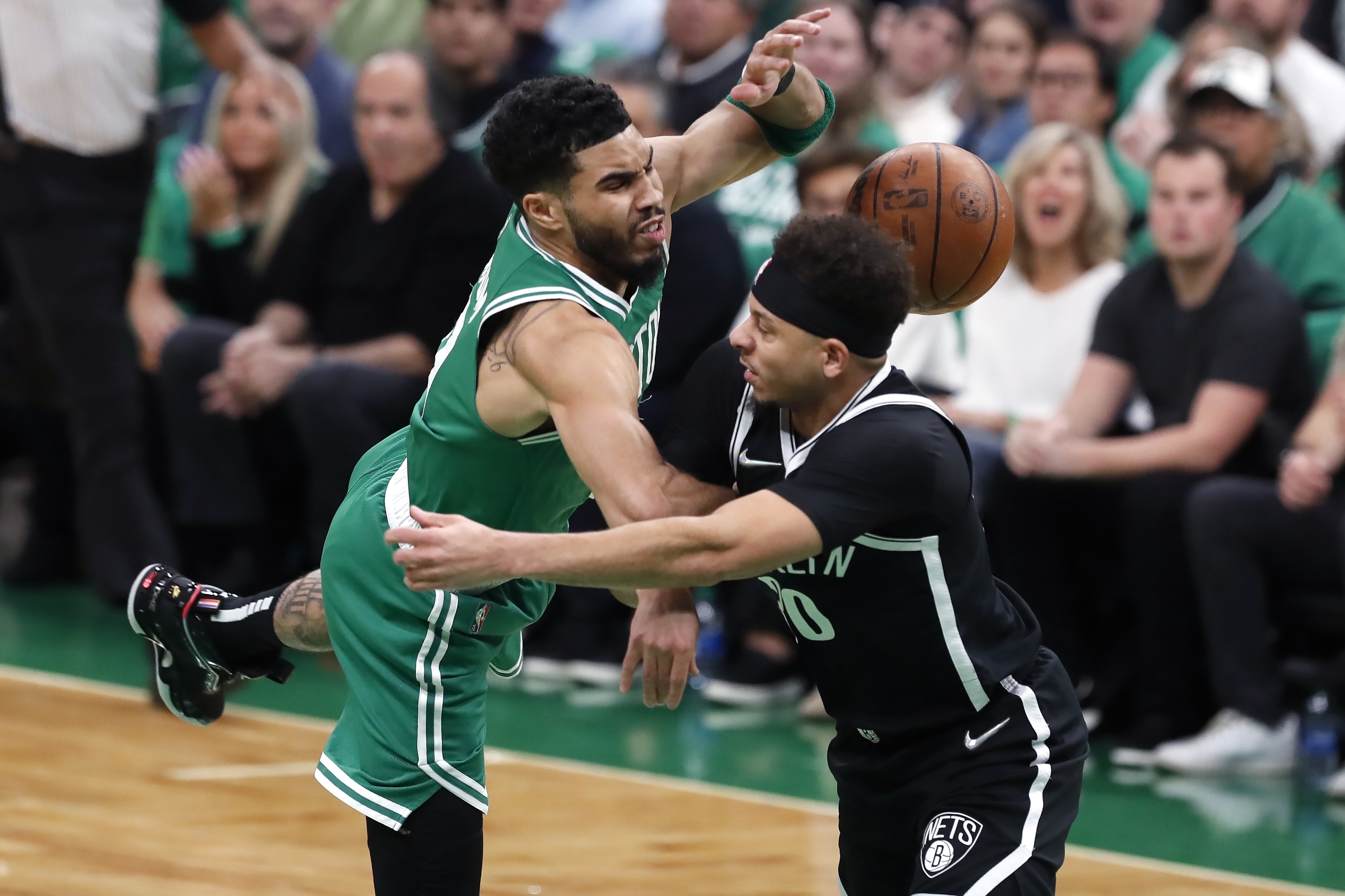 Brooklyn Nets' Seth Curry, right, commits a flagrant foul on Boston Celtics' Jayson Tatum during the first half of Game 2 of an NBA basketball first-round Eastern Conference playoff series Wednesday, April 20, 2022, in Boston. 