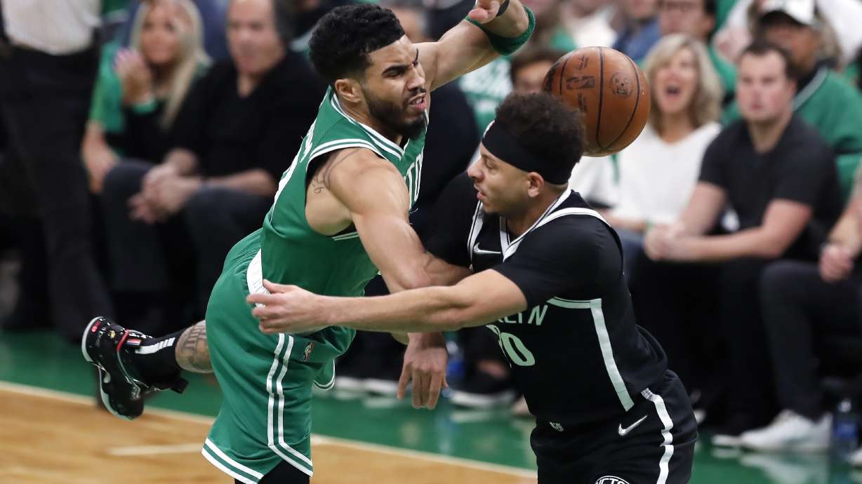 Brooklyn Nets' Seth Curry, right, commits a flagrant foul on Boston Celtics' Jayson Tatum during the first half of Game 2 of an NBA basketball first-round Eastern Conference playoff series Wednesday, April 20, 2022, in Boston.
