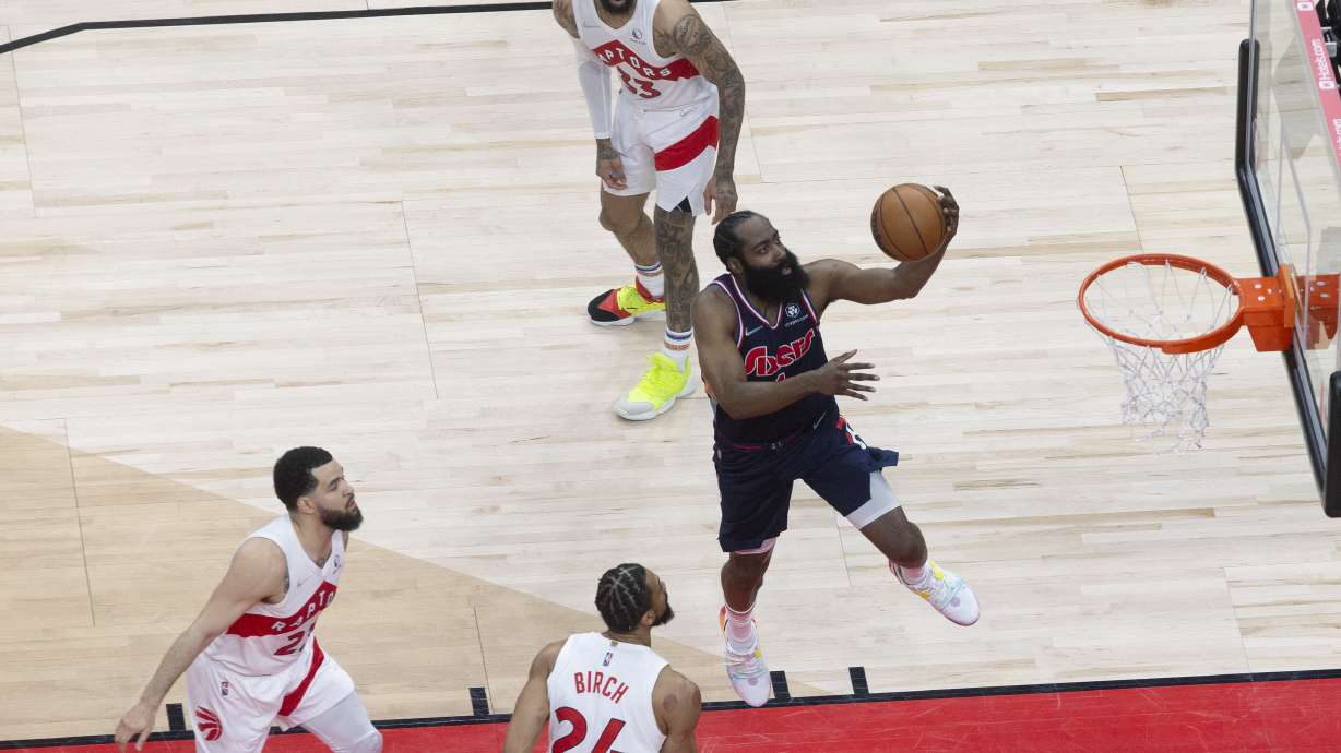 Philadelphia 76ers guard James Harden (1) scores against the Toronto Raptors during the first half of Game 3 of an NBA basketball first-round playoff series, Wednesday, April 20, 2022, in Toronto.