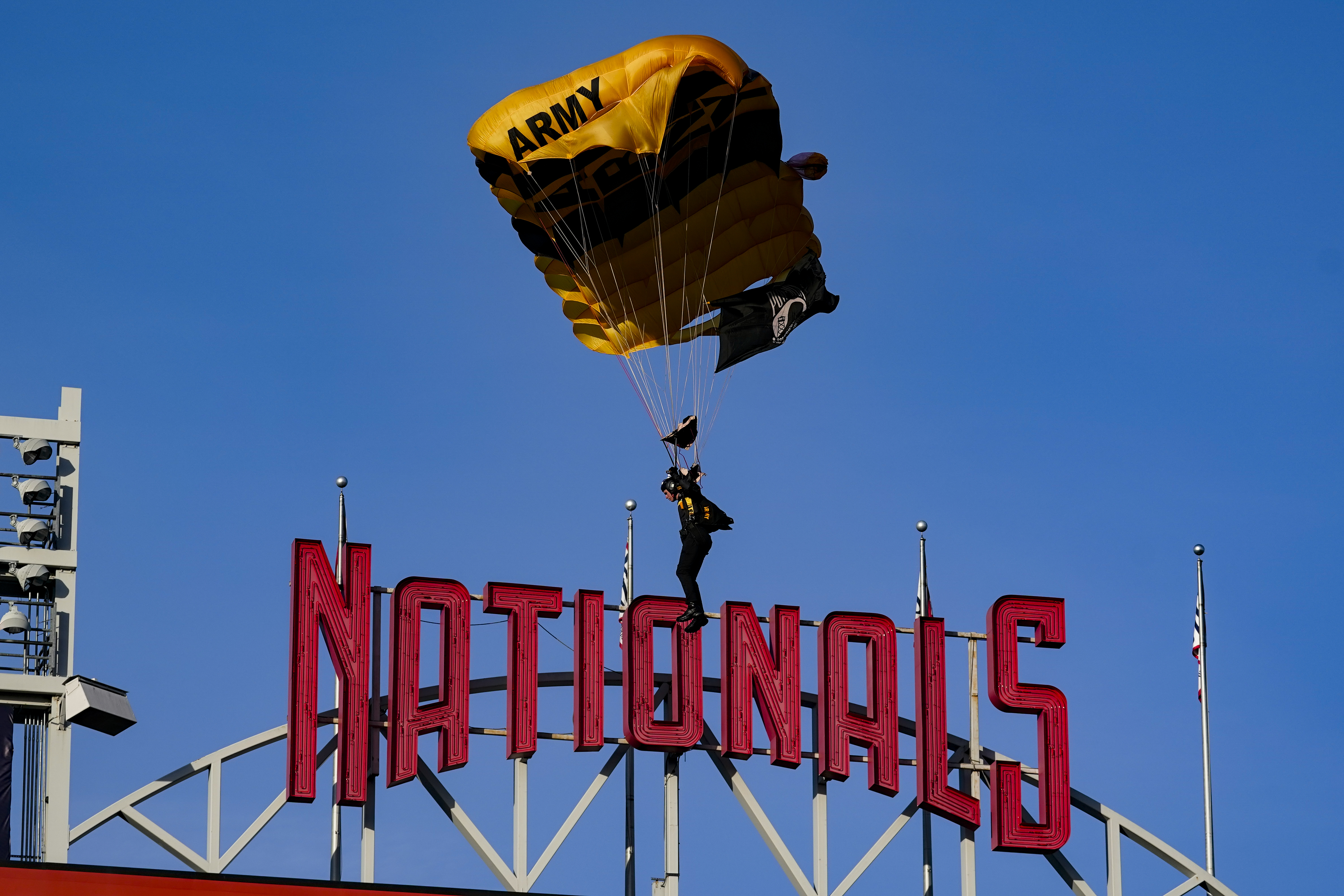 The U.S. Army Parachute Team the Golden Knights descend into National Park before a baseball game between the Washington Nationals and the Arizona Diamondbacks Wednesday, April 20, 2022, in Washington. The U.S. Capitol was briefly evacuated after police said they were tracking an aircraft “that poses a probable threat,” but the plane turned out to be the military aircraft with people parachuting out of it for a demonstration at the Nationals game, officials told The Associated Press. 