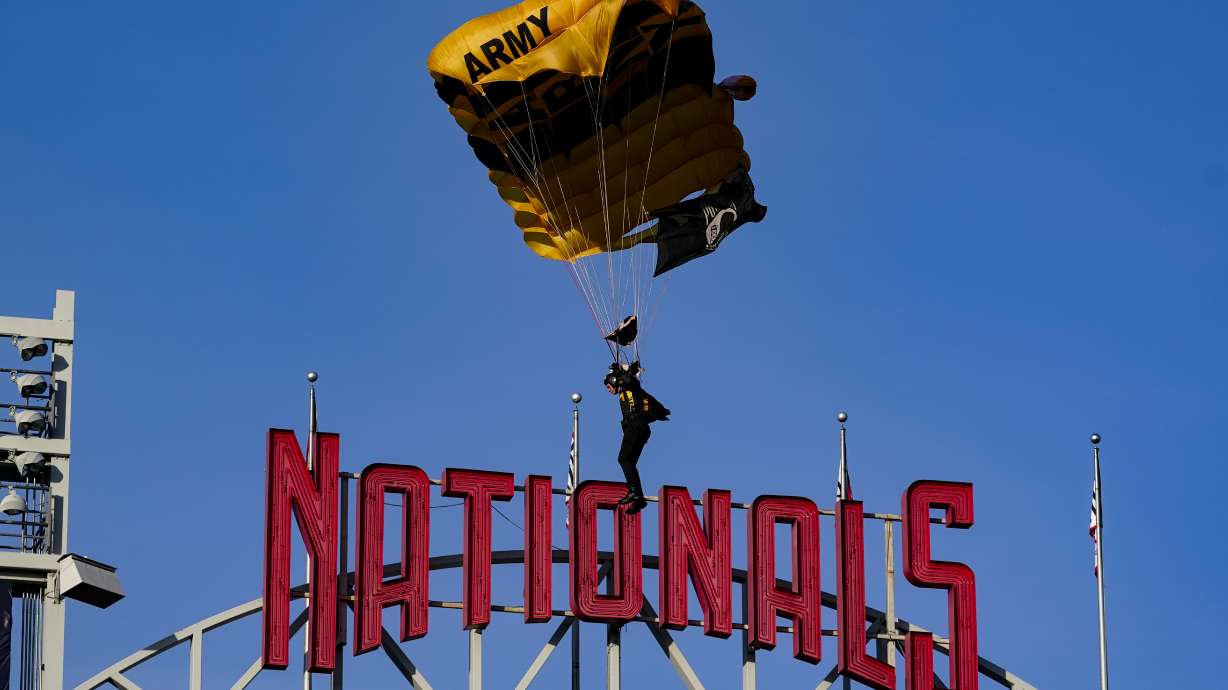 The U.S. Army Parachute Team the Golden Knights descend into National Park before a baseball game between the Washington Nationals and the Arizona Diamondbacks Wednesday, April 20, 2022, in Washington. The U.S. Capitol was briefly evacuated after police said they were tracking an aircraft “that poses a probable threat,” but the plane turned out to be the military aircraft with people parachuting out of it for a demonstration at the Nationals game, officials told The Associated Press.