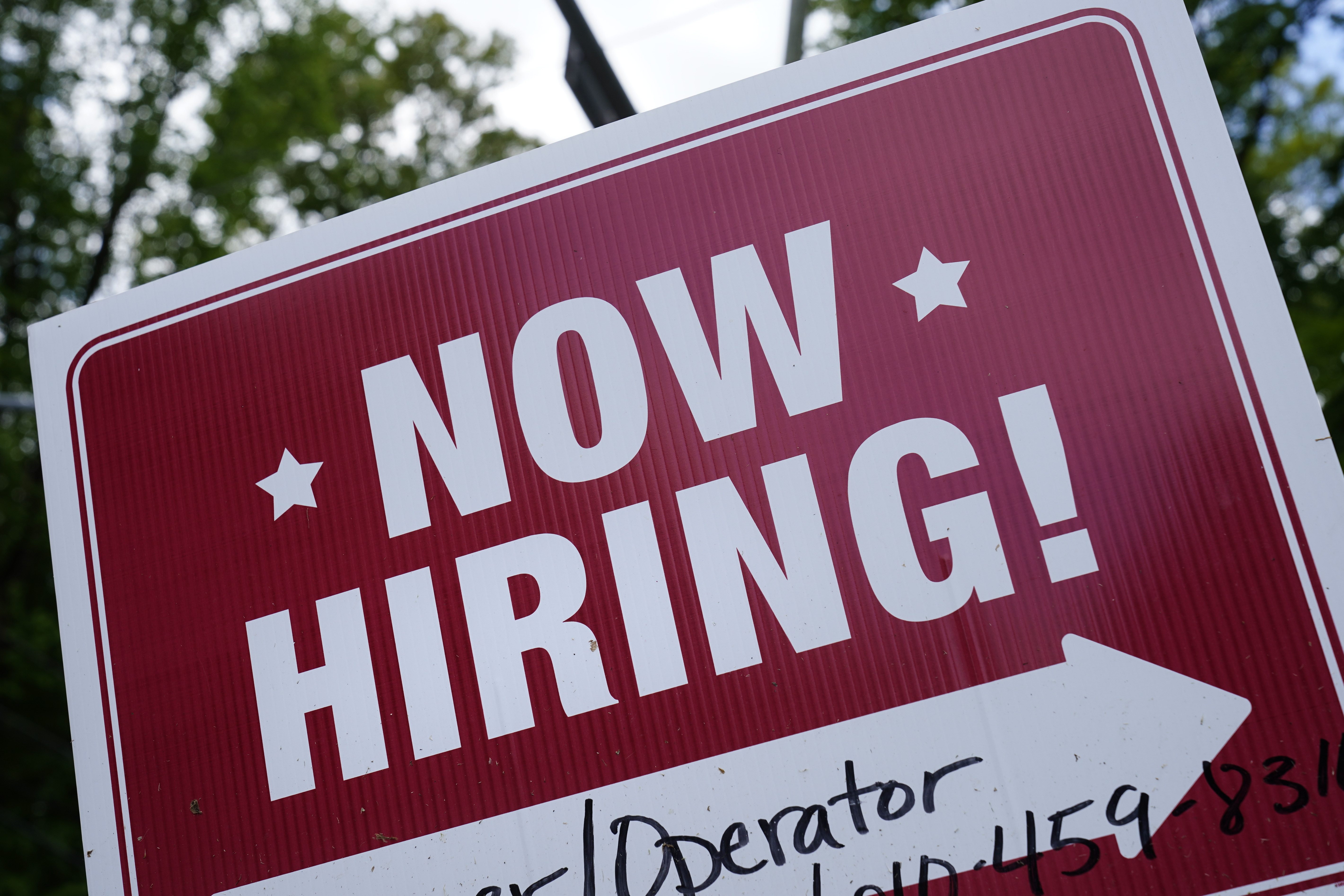 A "now hiring" sign is posted in Garnet Valley, Pa., May 10, 2021. Applications for unemployment benefits inched down last week as the total number of Americans collecting aid fell to its lowest level in more than 50 years, the U.S. Department of Labor reported Thursday.  