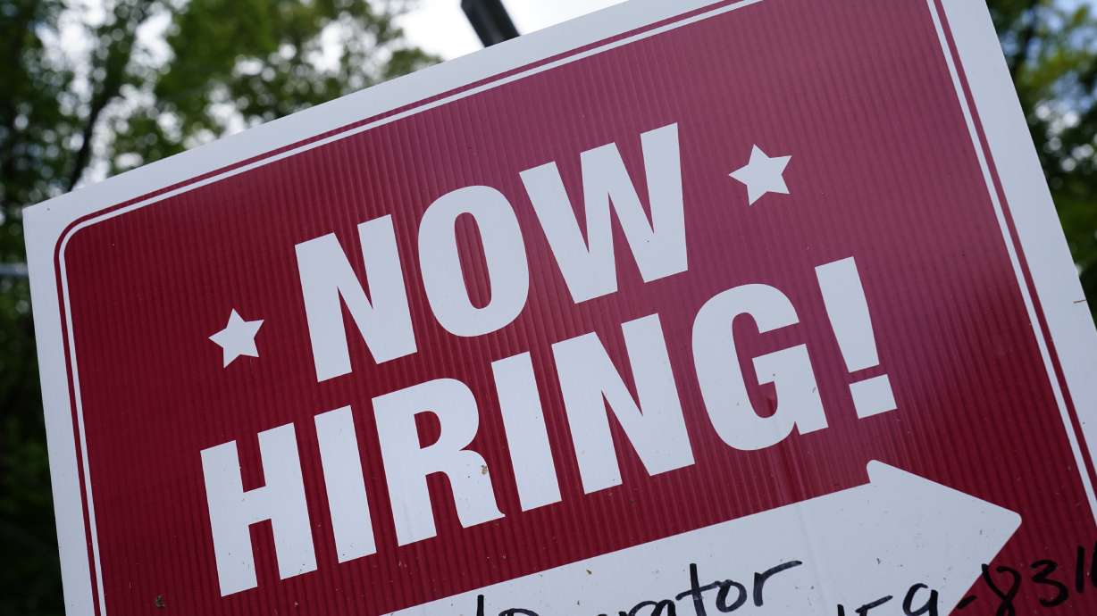 A "now hiring" sign is posted in Garnet Valley, Pa., May 10, 2021. Applications for unemployment benefits inched down last week as the total number of Americans collecting aid fell to its lowest level in more than 50 years, the U.S. Department of Labor reported Thursday.