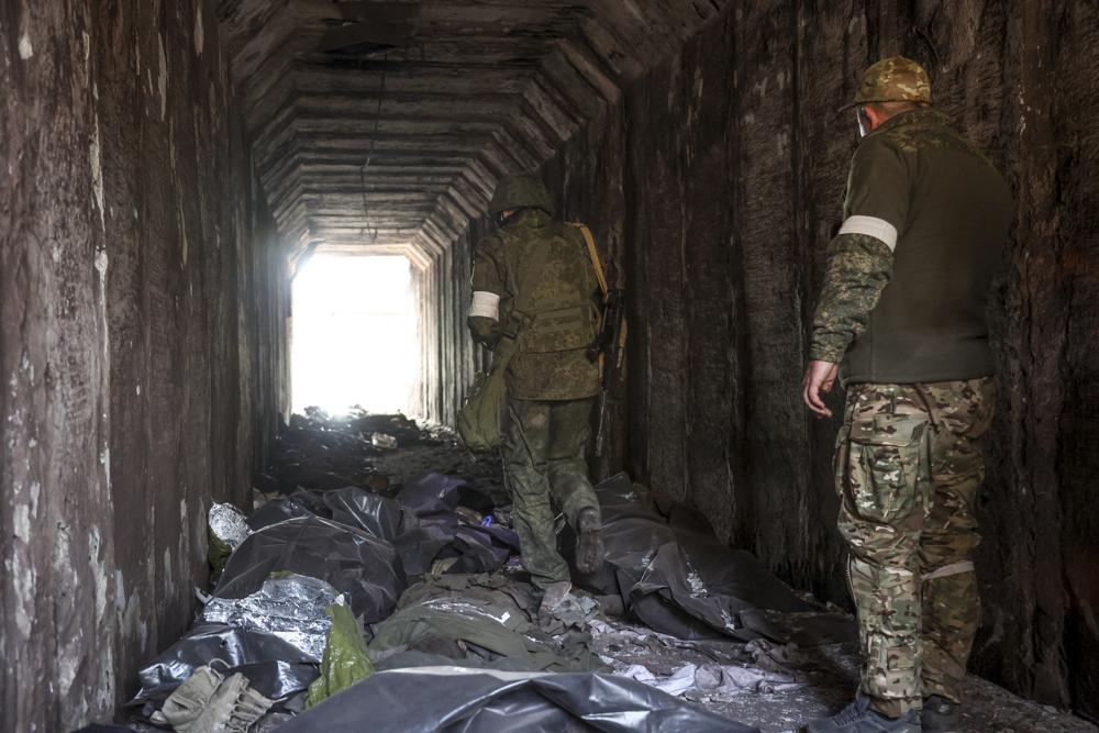 Servicemen of the Donetsk People's Republic militia look at bodies of Ukrainian soldiers placed in plastic bags in a tunnel, part of a steel factory in an area controlled by Russian-backed separatist forces in Mariupol, Ukraine, Monday. On Thursday,  Russian President Vladimir Putin ordered his forces not to storm the last remaining Ukrainian stronghold in the besieged city of Mariupol.
