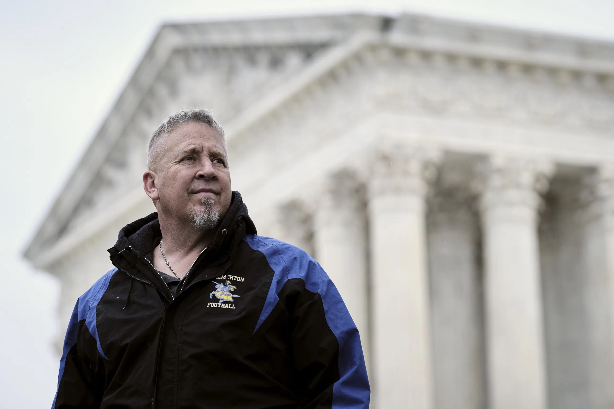 Joe Kennedy, a former assistant high school football coach in Bremerton, Washington, stands outside of the Supreme Court in Washington on April 5. The court has agreed to hear a case he brought against the Bremerton School District that put him on leave after he refused to cease his practice of kneeling on the field for a post-game prayer.