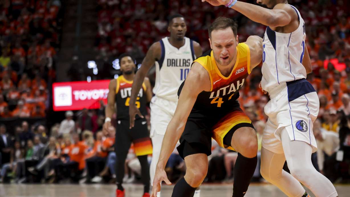 Utah Jazz forward Bojan Bogdanovic (44) drives on Dallas Mavericks guard Spencer Dinwiddie (26) as the Utah Jazz and Dallas Mavericks play an NBA basketball game at Vivint Arena in Salt Lake City on Thursday, April 21, 2022.