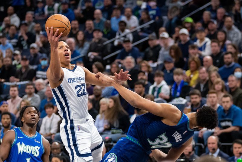 Apr 21, 2022; Minneapolis, Minnesota, USA; Memphis Grizzlies guard Desmond Bane (22) shoots against the Minnesota Timberwolves center Karl-Anthony Towns (32) in the first quarter during game one of the three round for the 2022 NBA playoffs at Target Center.