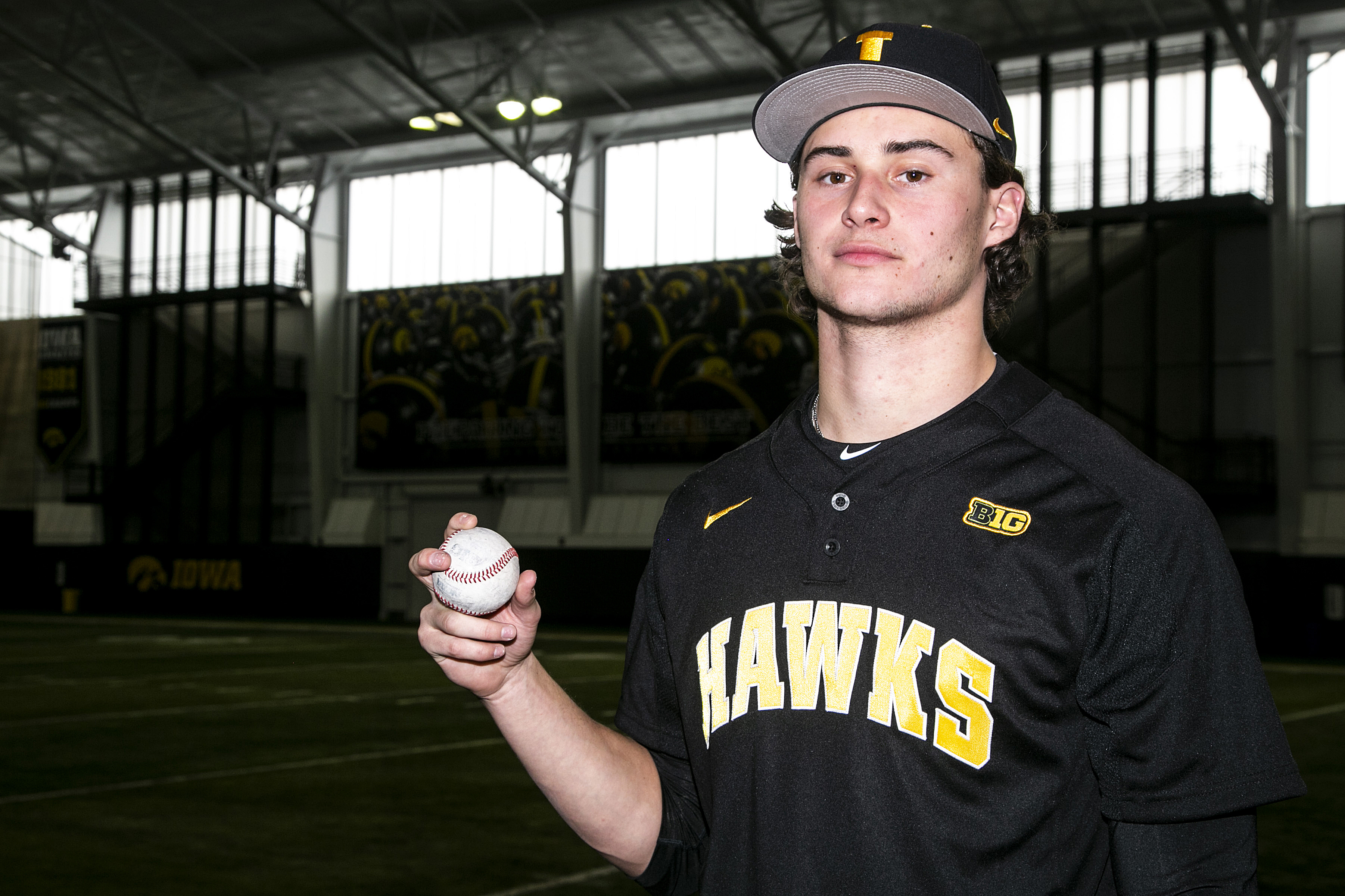 FILE - Iowa pitcher Brody Brecht poses for a photo during an NCAA college baseball media day, Feb. 10, 2022, at the University of Iowa Indoor Practice Facility in Iowa City, Iowa. The Iowa freshman is working double-duty this spring  as a pitcher on the baseball team and a wide receiver on the football team. 