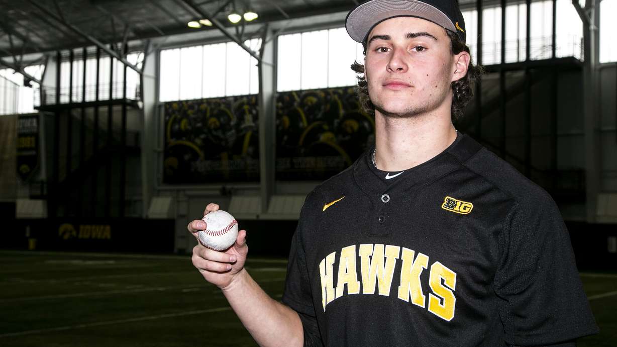 FILE - Iowa pitcher Brody Brecht poses for a photo during an NCAA college baseball media day, Feb. 10, 2022, at the University of Iowa Indoor Practice Facility in Iowa City, Iowa. The Iowa freshman is working double-duty this spring as a pitcher on the baseball team and a wide receiver on the football team.