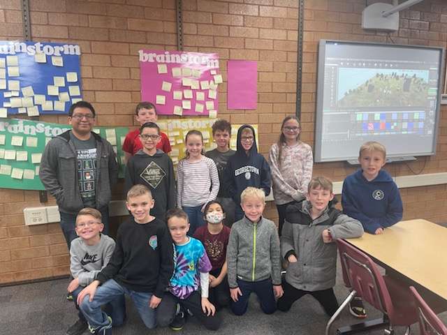 Josh Poll, far left, stands with the South Weber Elementary School third grade schoolwide enrichment model class. Third- through sixth-grade students who have excelled in math are in the process of creating math-based computer games based on district math objectives with the help of Poll.